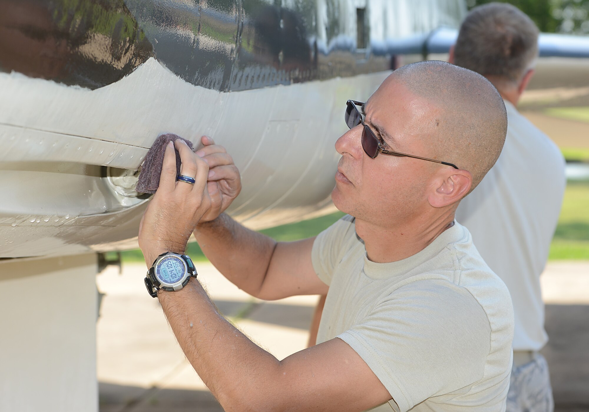 Chief Master Sergeant Dennis Dipiazzo, 138th Communication Flight Chief, scrubs dirt from the fuselage of an F-100 static display aircraft at the Tulsa Air National Guard base, Tulsa Okla., 29 July 2014.  Members of the 138th FW Chiefs Council gathered to wash the static aircraft in an effort to keep them looking nice for public display.  (U.S. National Guard photo by Senior Master Sgt.  Preston L. Chasteen/Released)