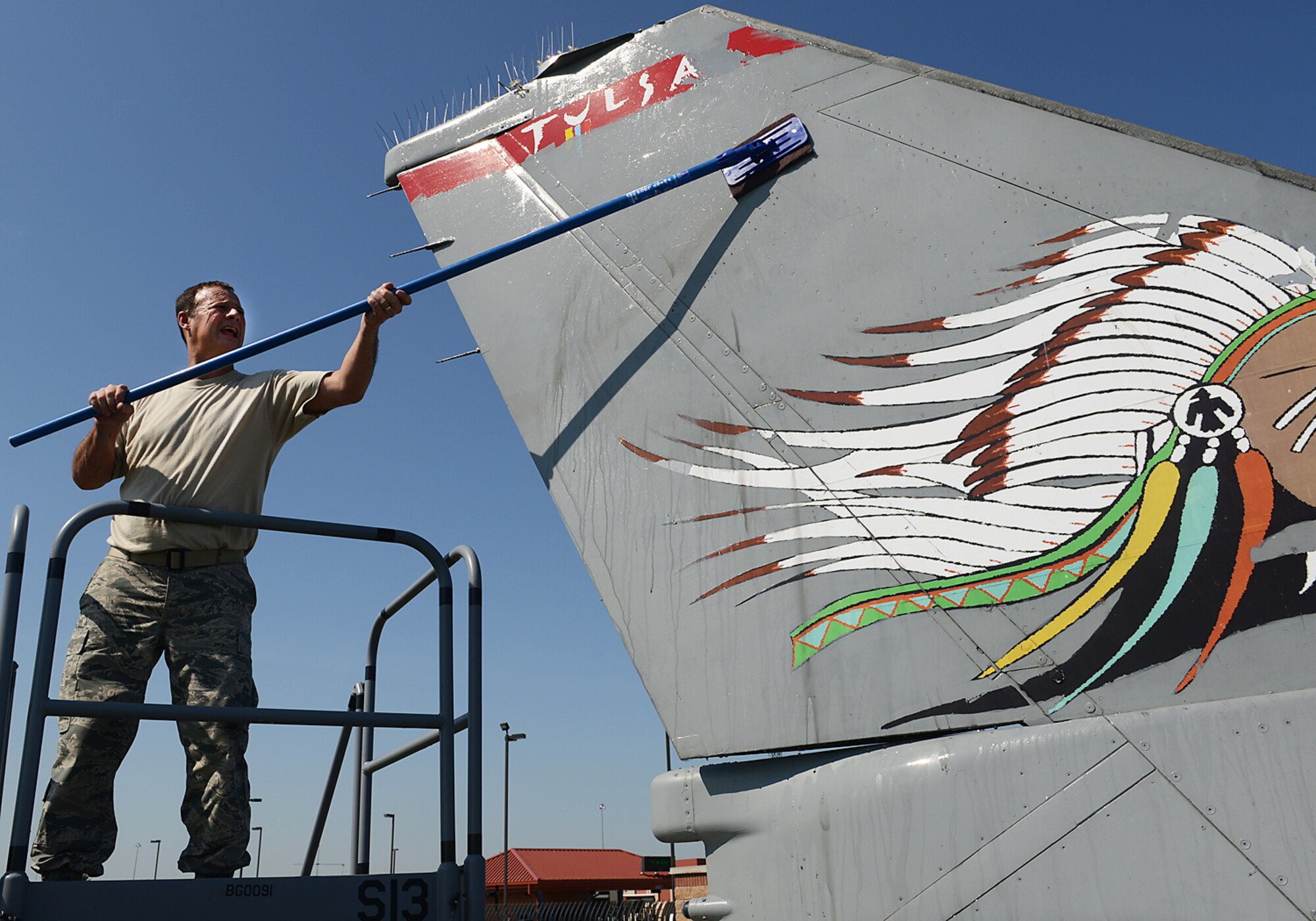 Chief Master Sergeant Brian Williams, 138th Maintenance Group Chief, scrubs the tail of an F-16 static display aircraft at the Tulsa Air National Guard base, Tulsa Okla., 29 July 2014.  Members of the 138th FW Chiefs Council gathered to wash the static aircraft in an effort to keep them looking nice for public display.  (U.S. National Guard photo by Senior Master Sgt.  Preston L. Chasteen/Released)