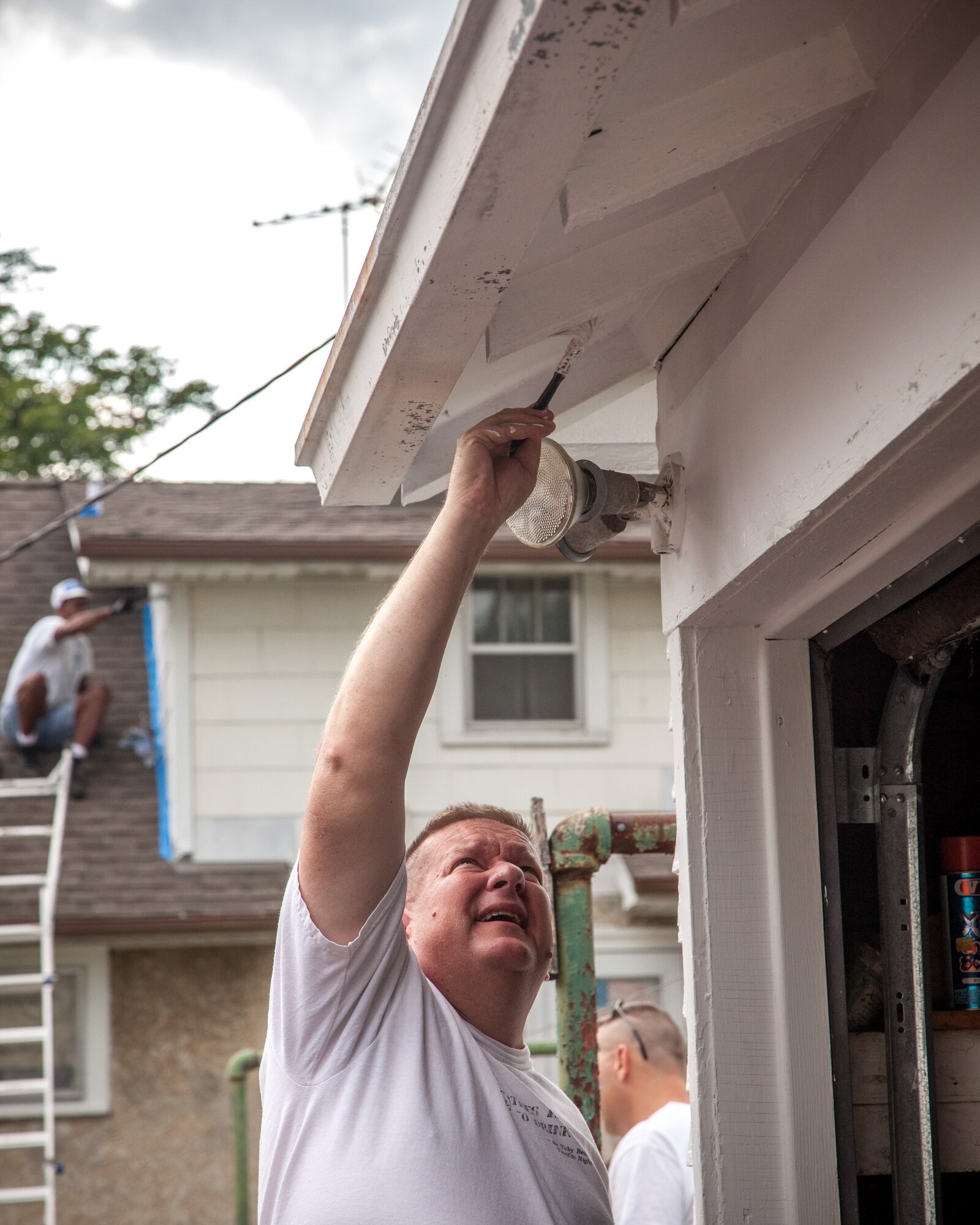 Members of the 934th Airlift Wing volunteer to help out  a homeowner in Minneapolis through the Metro Paint-A-Thon program.  Wing members have been volunteering since 1988 and have painted and repaired over 21 homes in the metro area over the years. (U.S. Air Force photo/Shannon McKay)