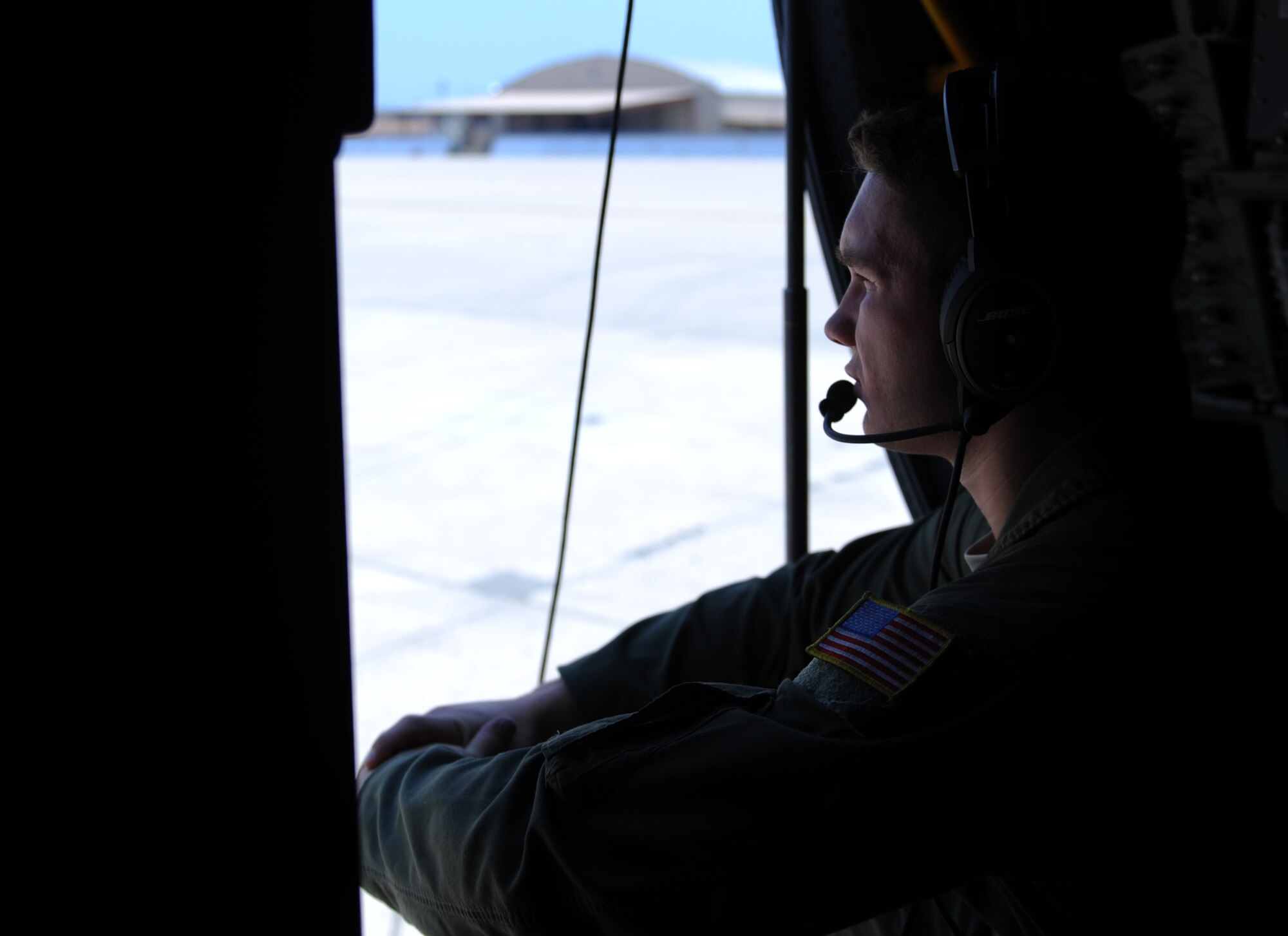 U.S. Air Force Airman 1st Class Jacob Betts, 40th Airlift Squadron loadmaster, sits in the doorway of a C-130J Super Hercules after completing a training exercise July 23, 2014, at Naval Air Station Joint Reserve Base Fort Worth, Texas. The exercise demonstrated the C-130J capabilities that will be used during Red Flag-Alaska, where more than 100 aircraft will participate in multiple exercises. (U.S. Air Force photo by Airman 1st Class Kedesha Pennant/Released)