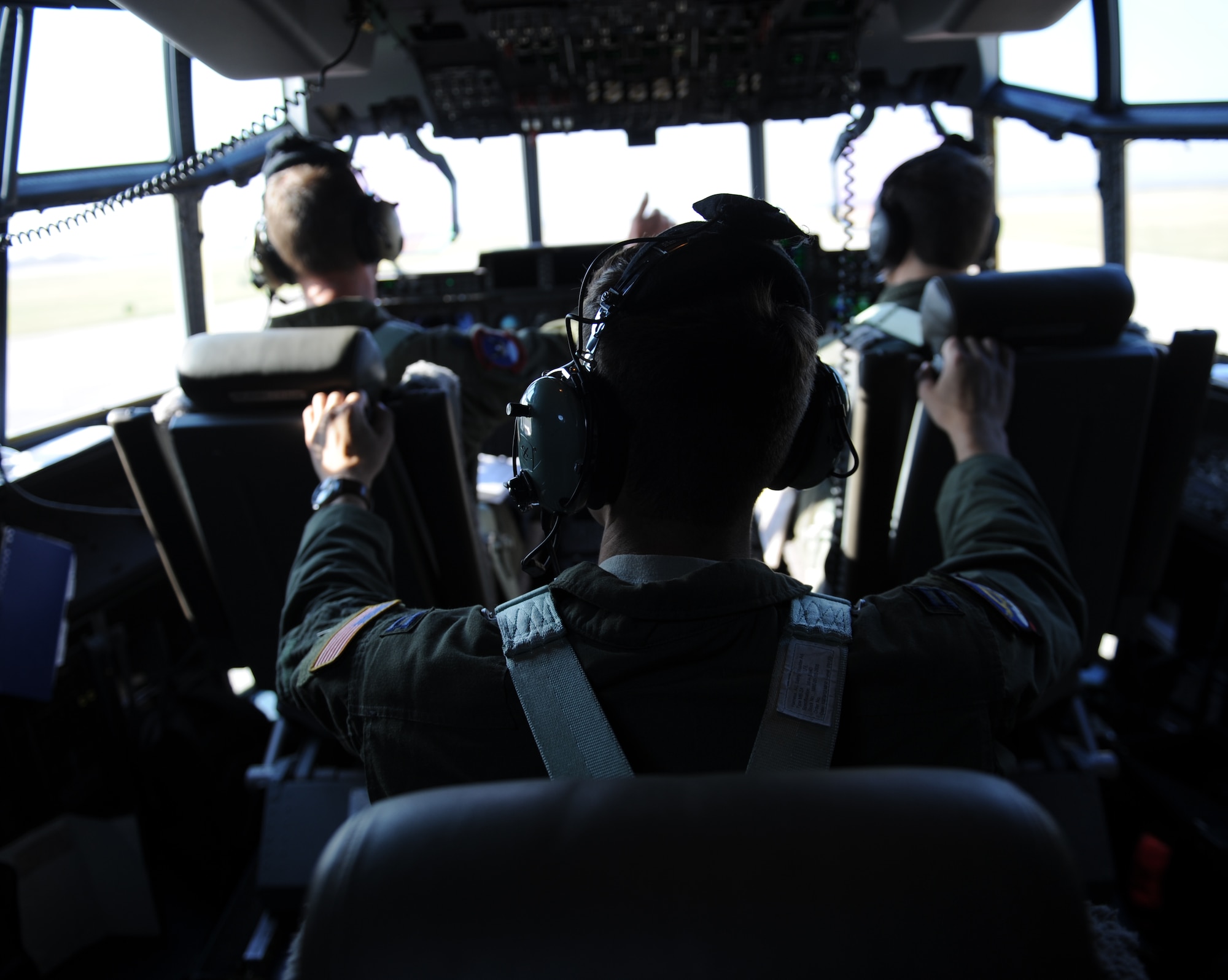 U.S. Air Force pilots prepare for takeoff in a C-130J Super Hercules July 23, 2014, at Dyess Air Force Base, Texas. Two 317th Airlift Group C-130Js successfully employed air-to-air tactics against an F-16 Fighting Falcon during a training exercise en route to Naval Air Station Joint Reserve Base Fort Worth, Texas. (U.S. Air Force photo by Airman 1st Class Kedesha Pennant/Released)
