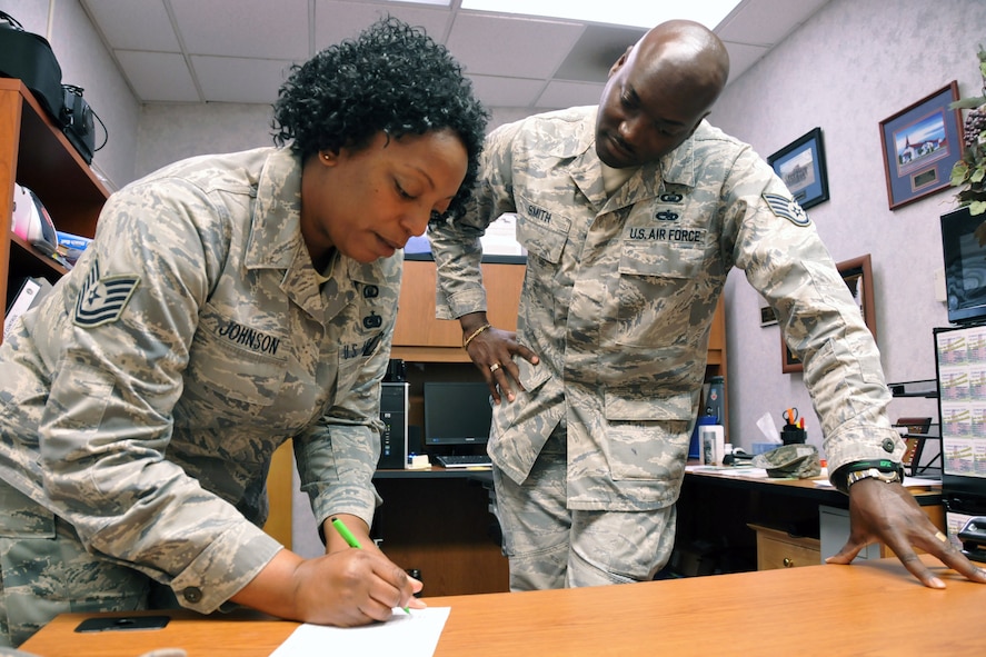 Tech. Sgt. Janell Johnson, NCO in charge of chaplain operations at the 916th ARW, gets assistance for a R.A.C.K. Attack event  from Tech. Sgt. Terrell Smith, NCO in charge of chapel training.  (USAF photo by SSgt. Terrica Y. Jones, 916ARW/PA)