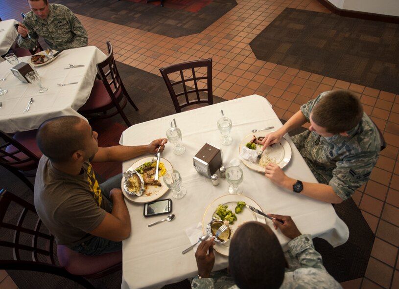 Airmen gather during a quarterly birthday meal at Moody Air Force Base, Ga., July 30, 2014. The menu for the birthday meal consisted of Mediterranean-basil salmon, barbecue ribs, barbecue chicken, mixed vegetables, rice pilaf and twice-baked potato. (U.S. Air Force photo by Senior Airman Jarrod Grammel/Released)
