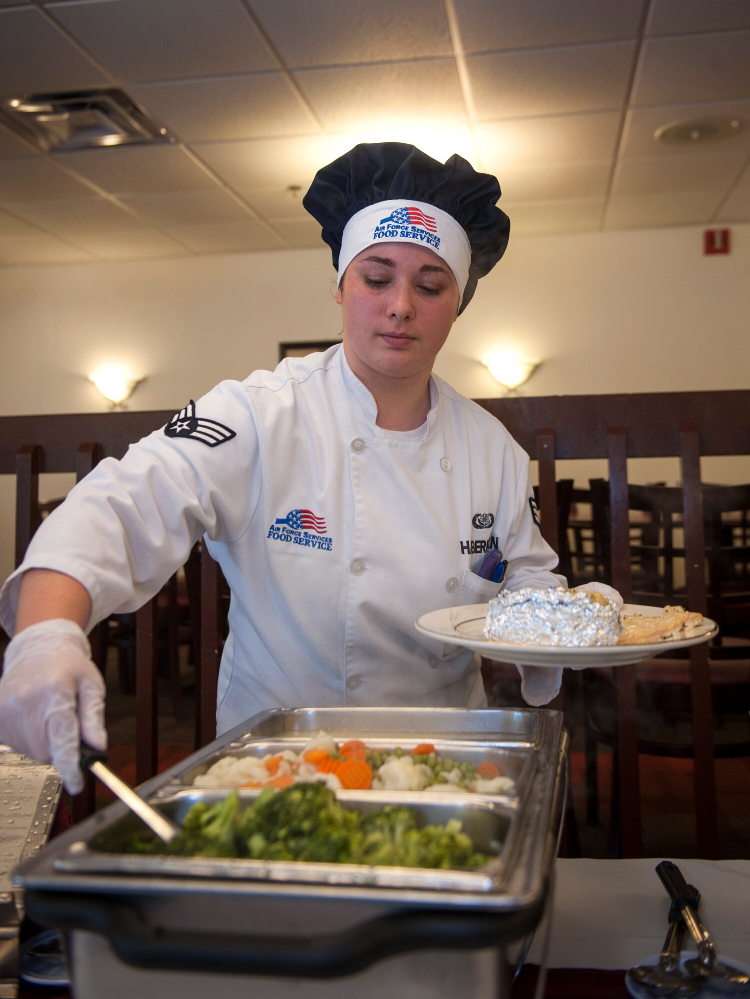U.S. Air Force Senior Airman Leah Haberkorn, 23d Force Support Squadron services journeyman, prepares a plate for a quarterly birthday meal at Moody Air Force Base, Ga., July 30, 2014. The dining facility staff invited Airmen with meal cards who had birthdays between May 1 and July 31 to the event. (U.S. Air Force photo by Senior Airman Jarrod Grammel/Released
