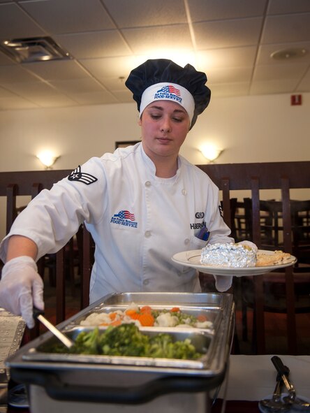 U.S. Air Force Senior Airman Leah Haberkorn, 23d Force Support Squadron services journeyman, prepares a plate for a quarterly birthday meal at Moody Air Force Base, Ga., July 30, 2014. The dining facility staff invited Airmen with meal cards who had birthdays between May 1 and July 31 to the event. (U.S. Air Force photo by Senior Airman Jarrod Grammel/Released
