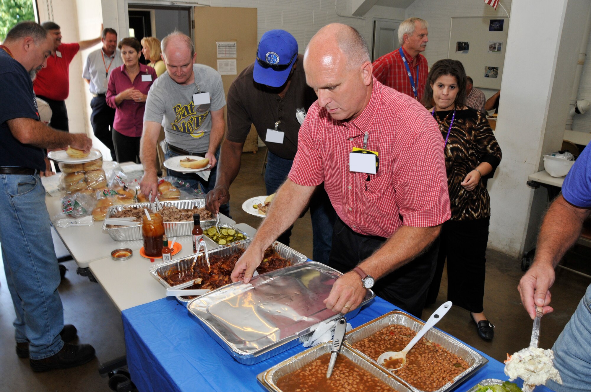In recognition of the job well done on the Woods Dam project, an appreciation luncheon was held for the Arnold Engineering Development Complex (AEDC) Test Support personnel involved in completing the repairs. Several crews, both internal and external, were involved in the harmonization and work flow of materials, fabrication, delivery and installation of three platforms, installation of six new cables, fabrication and installation of the drum assembly, modification to five trunnion pins and painting for the platforms. The team also successfully removed the bulk head from one of the sluice gates. Branch managers commend the crews for their overall safety in completing this project. They worked a total of 6,831 hours without any major incidents. Pictured front right is Ronnie Skipworth, Utilities and Engineering Services branch manager, with the project crews at the recent luncheon. (Photo by Rick Goodfriend)  