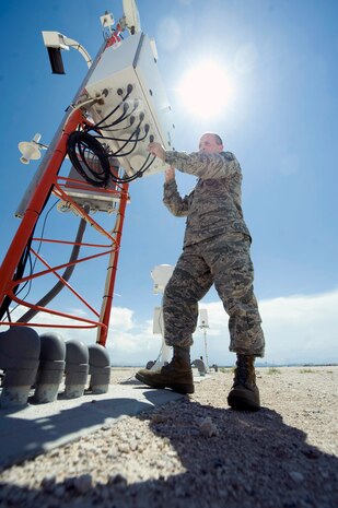 Master Sgt. Adam D'Anthony, 57th Operations Support Squadron airfield weather support NCO in charge, checks a AN/FMQ-19, Automatic Metrological Station,  July 28, 2014, at Nellis Air Force Base, Nev. The FMQ-19 is an automated weather observation device that provides 24-hour weather observations for the base. (U.S. Air Force photo by Airman 1st Class Rachel Loftis)