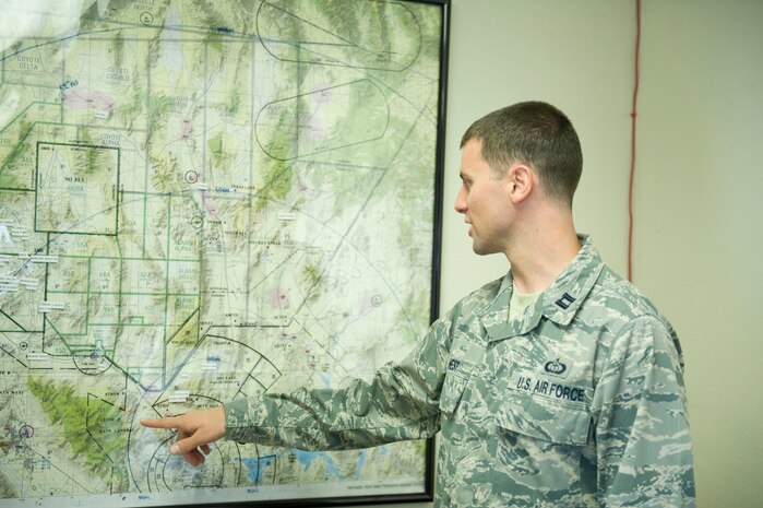 Capt. Tyler West, 57th Operations Support Squadron weather flight commander, explains weather forecasters’ mission, July 28, 2014, at Nellis Air Force Base, Nev. Weather forecasters are instrumental in providing warfighters with the most accurate mission execution forecast for not only the base, but the ranges as well. (U.S. Air Force photo by Airman 1st Class Rachel Loftis)