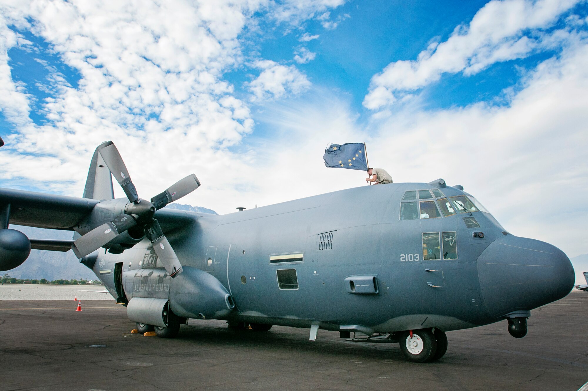Pictured is an Alaska Air National Guard HC-130 King aircraft, the type of aircraft used in the transport of a pregnant woman to Anchorage from Nulato July 28, 2014. Here, Master Sgt. Ed Kenna, a communications navigation technician with the 176th Maintenance Squadron, Alaska Air National Guard, replaces a traffic collision avoidance system antenna atop the HC-130 from the 211th Rescue Squadron before departing from the Palm Springs International Airport, Palm Springs, California, Nov. 19, 2013. The Alaska Guardsmen were there to participate in an Integrated Training Exercise at the Marine Corps Air Ground Combat Training Center in Twentynine Palms, California, which is an exercise designed to validate units before deploying to Afghanistan. (U.S. Army National Guard file photo by Sgt. Edward Eagerton/Released)