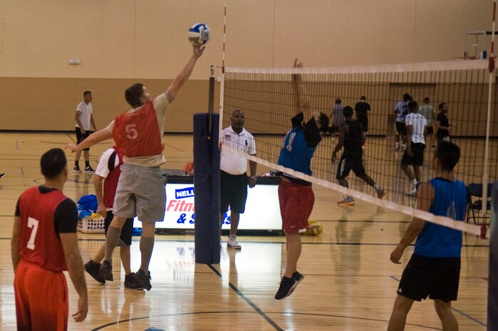 A member of the 57th Maintenance Squadron’s intramural volleyball team [red] hits the ball during a game against the 99th Security Forces Squadron [blue] at the Warrior Fitness Center, July 28, 2014, at Nellis Air Force Base, Nev. The 57th MXS beat the 99th SFS in two games. (U.S. Air Force Airman 1st Class Mikaley P. Towle)
