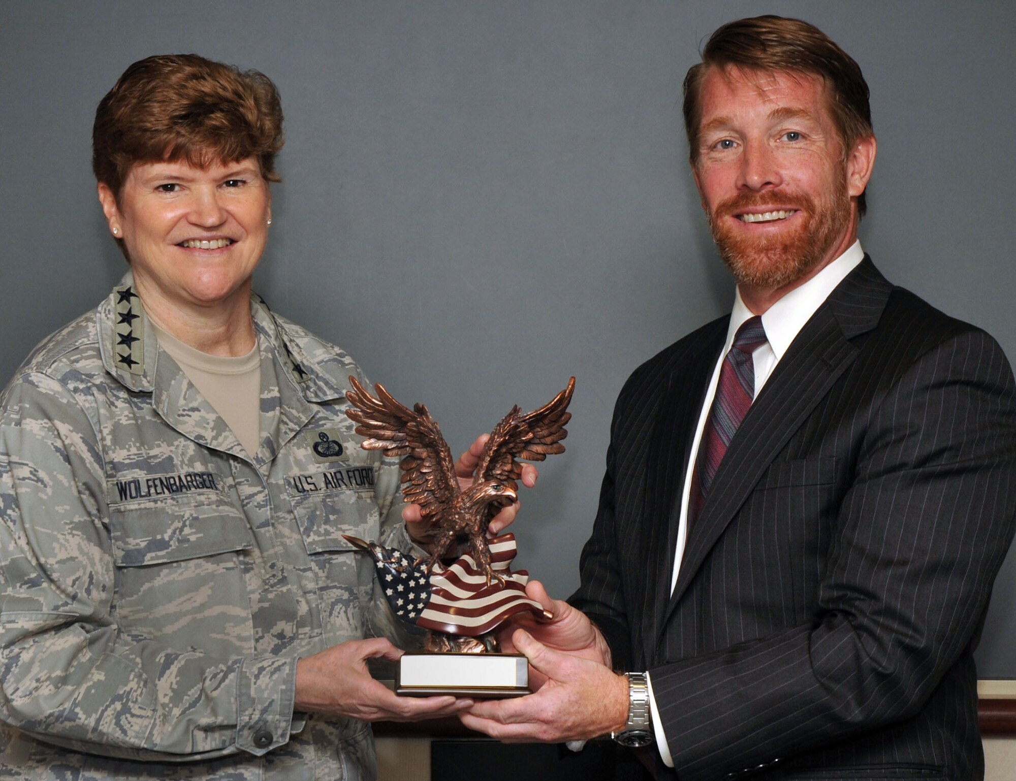 Mark Teskey, Air Force Director of Small Business Programs, presents Gen. Janet Wolfenbarger, Air Force Materiel Command commander, with the 2013 Secretary of the Air Force Small Business Director’s Top MAJCOM award July 24. AFMC has won this award for the second year in a row since the award’s inception in 2012. (U.S. Air Force photo/Michelle Gigante)