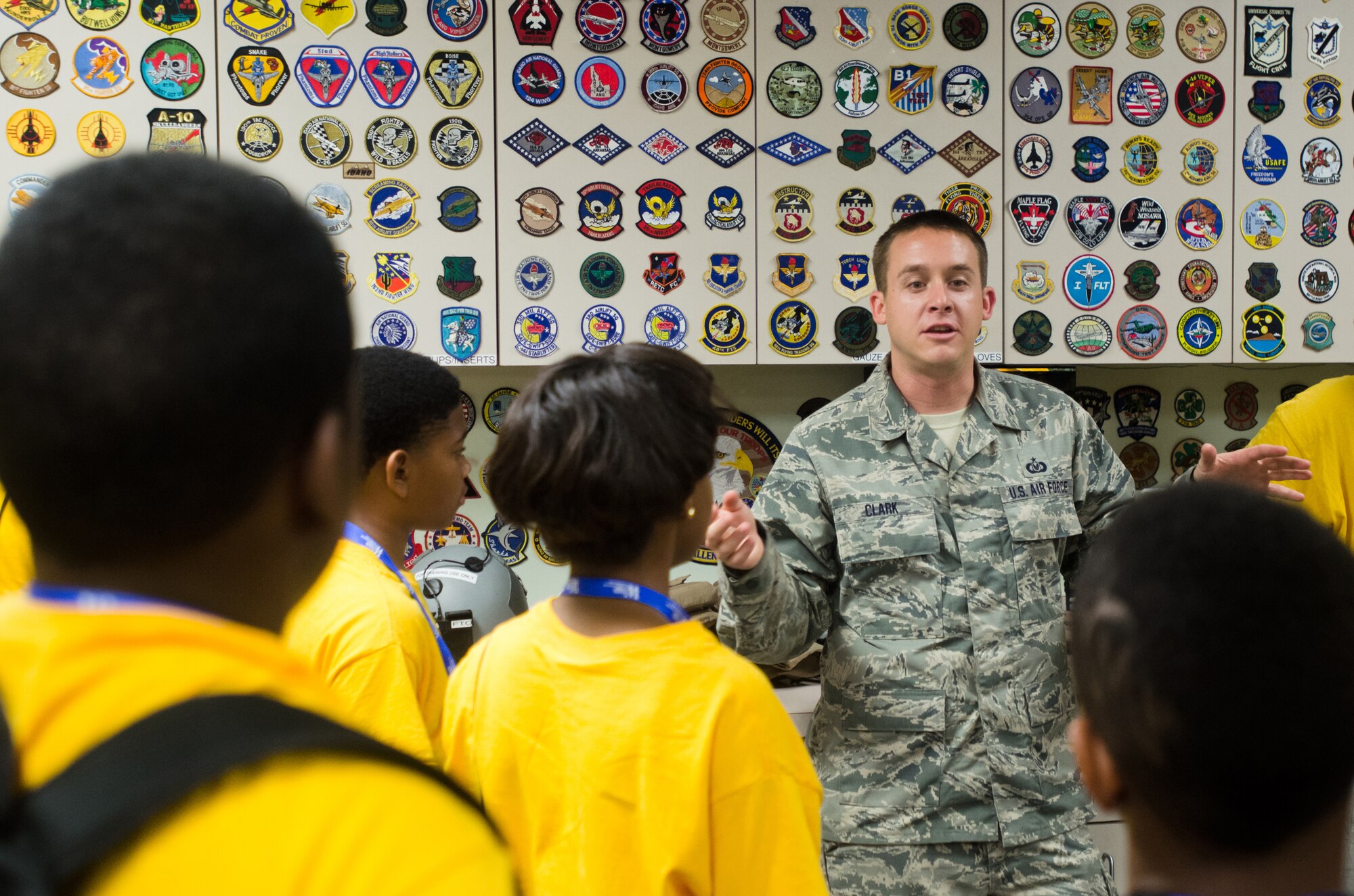 Tech. Sgt. David Clark, an aircrew flight equipment specialist for the Kentucky Air National Guard, answers questions from a group of local youths during a base-wide tour at the 123rd Airlift Wing in Louisville, Ky., on June 20, 2014. The visit was part of an aviation camp sponsored by the Organization of Black Aerospace Professionals designed to stimulate interest in the aerospace community. (U.S. Air National Guard photo by Senior Airman Joshua Horton)