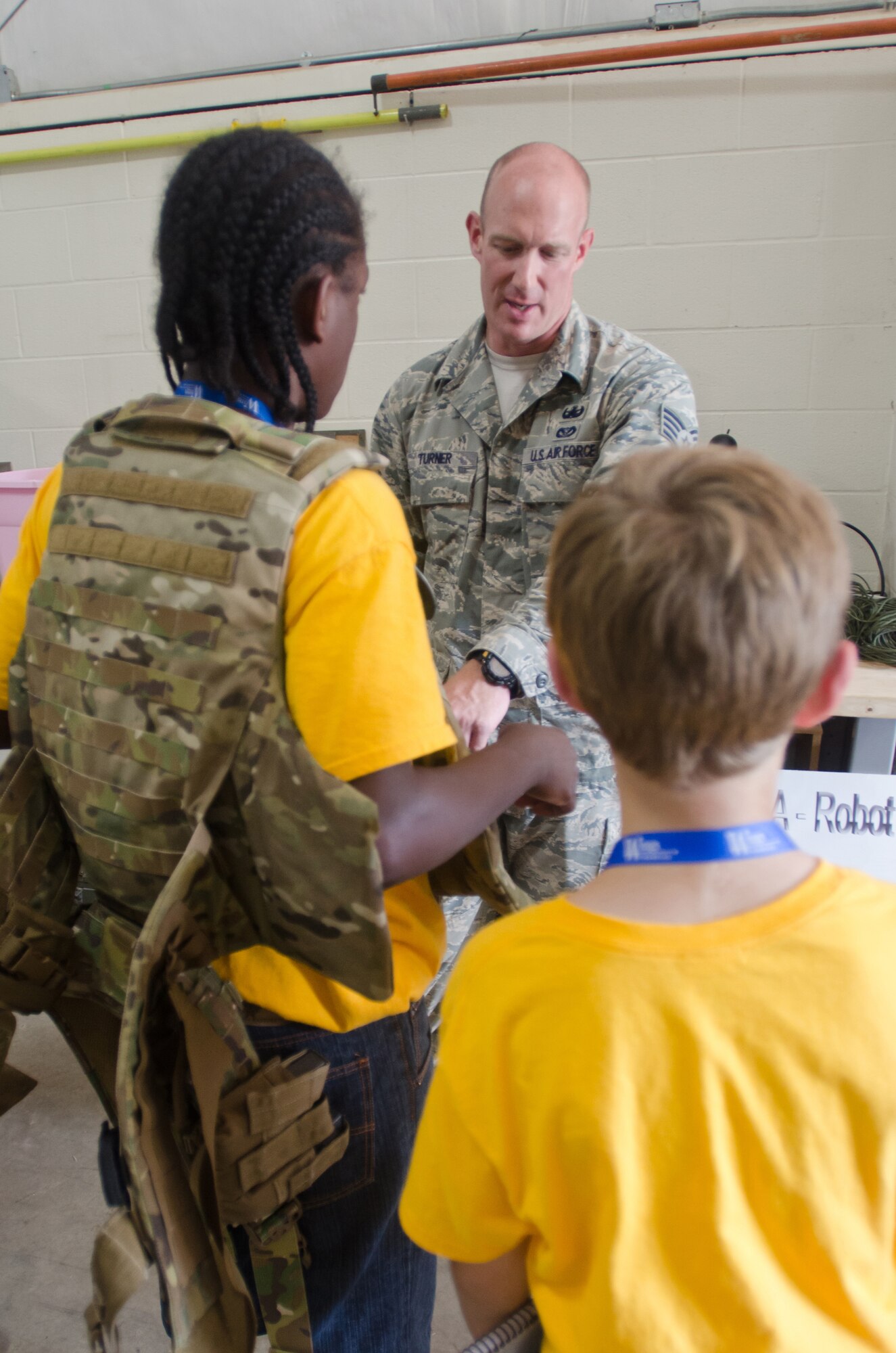 Staff Sgt. Dustin Turner, a member of the Kentucky Air National Guard’s Explosive Ordinance Disposal Flight, explains EOD protective equipment to a group of local youths during a base-wide tour at the 123rd Airlift Wing in Louisville, Ky., on June 20, 2014. The visit was part of an aviation camp sponsored by the Organization of Black Aerospace Professionals designed to stimulate interest in the aerospace community. (U.S. Air National Guard photo by Senior Airman Joshua Horton)