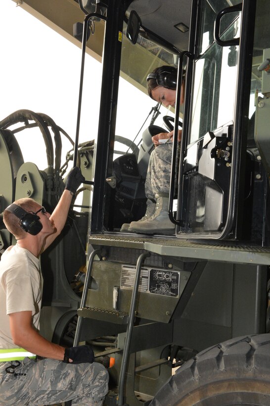 Staff Sgt. Christina Ebel, Senior Airman Tyler Kleinschmit, Staff Sgt. Melissa Kammin, and Tech. Sgt. Evan Littrell practice off-loading cargo pallets from a 60K Aircraft Tunner with two Transportation Proficiency Center instructors at Dobbins Air Reserve Base, Georgia, during the 155th Small Air Terminal annual proficiency training July 11-14, 2014. 