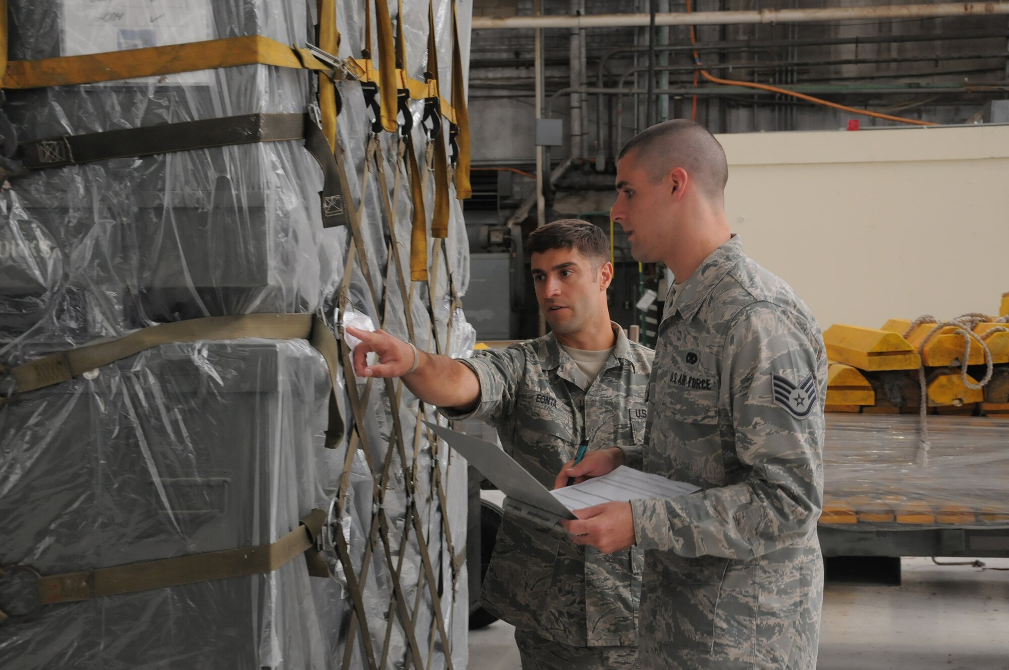 WRIGHT-PATTERSON AIR FORCE BASE, Ohio – Tech. Sgt. Michael Eonta and Staff Sgt. Eric Wadlington, both assigned to the 87th Aerial Port Squadron, verify the accuracy of shipping information on a cargo pallet during pallet build training on July 19, 2014. The reservists received the training to upgrade their proficiency in their career field. (U.S. Air Force photo/Tech. Sgt. Anthony G. Springer)