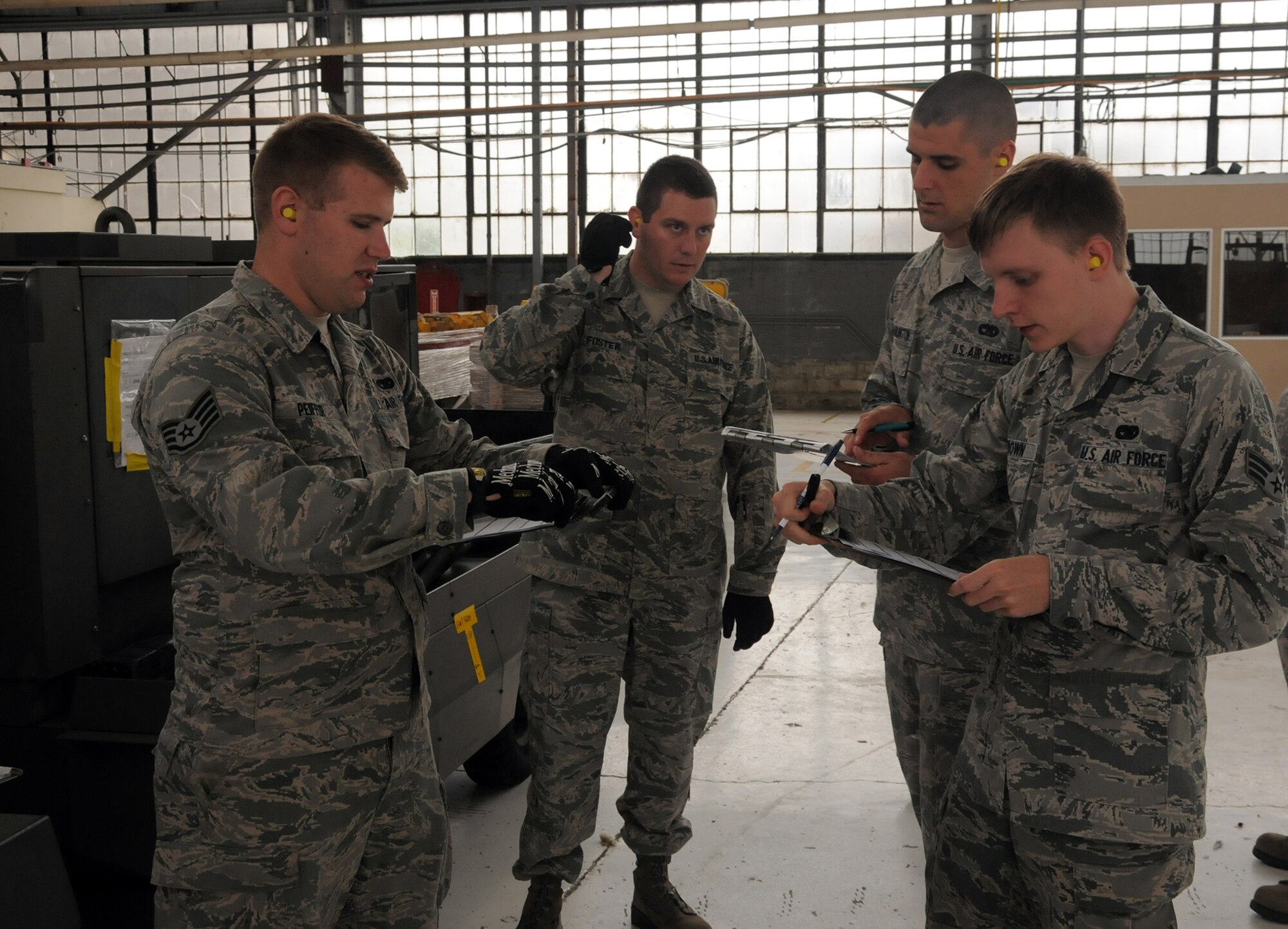 WRIGHT-PATTERSON AIR FORCE BASE, Ohio – 87th Aerial Port Squadron reservists Staff Sgt. Alexander Peiffer, Tech. Sgt. Matthew Foster (training facilitator), Staff Sgt. Eric Wadlington and  Senior Airman Corey Brown. review data collected during pallet building training during the July 19, 2014, unit training assembly. (U.S. Air Force photo/Tech. Sgt. Anthony G. Springer)