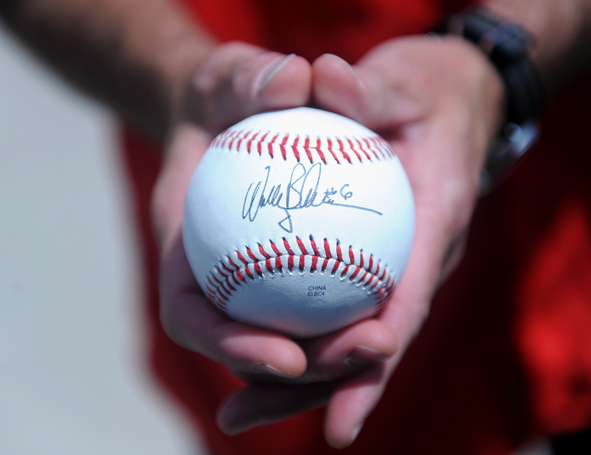 Maj. Gen. Jay Silveria, U.S. Air Force Warfare Center commander, holds a baseball signed by Wally Backman, the Las Vegas 51s manager, before the team’s game against the Salt Lake Bees at Cashman Field in Las Vegas, Nev., July 27, 2014. Silveria, who has has been a fan of the 51s’ manager since Backman played second base for the New York Mets, used the ball to throw out the game’s ceremonial first pitch. (U.S. Air Force photo by Staff Sgt. Siuta B. Ika)