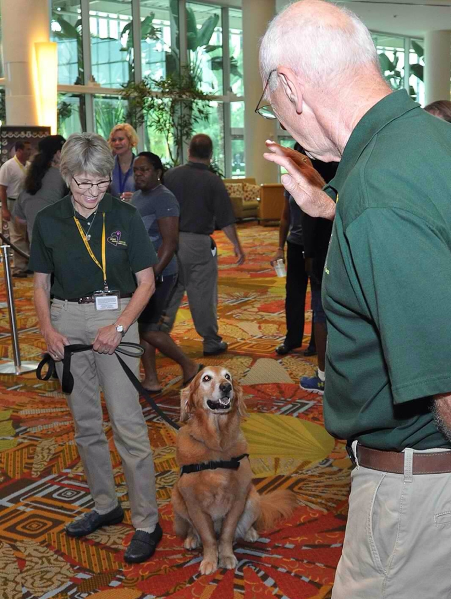 HOPE Animal-Assisted Crisis Response representatives Kathy and Jerry Constantino work with service dog Tess July 25, 2014, during an Air Force Reserve Yellow Ribbon training weekend in Orlando, Florida. The program promotes the well-being of reservists and their loved ones by connecting them with resources before and after deployments. (U.S. Air Force photo by Master Sgt. James Branch)