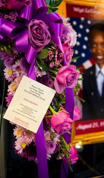 Flowers from the 23d Medical Group rest on a stand during a memorial ceremony for U.S. Air Force Master Sgt. LaTonya Dease at Moody Air Force Base, Ga., July 29, 2014. Dease passed away on July 24 and was assigned to the 23d Aerospace Medicine Squadron. (U.S. Air Force photo by Airman 1st Class Ceaira Tinsley/Released)