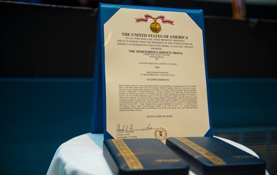 A Meritorious Service Medal rests on a table during a memorial ceremony for U.S. Air Force Master Sgt. LaTonya Dease at Moody Air Force Base, Ga., July 29, 2014. Dease received the medal posthumously in honor of her dedication to service to the Air Force. (U.S. Air Force photo by Airman 1st Class Ceaira Tinsley/Released)