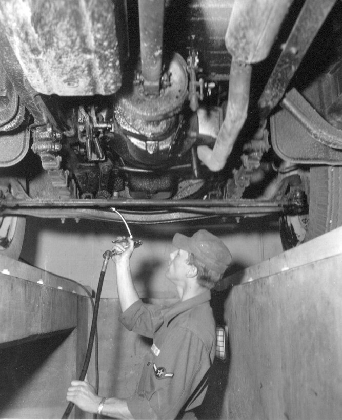 An unidentified Airman of the 142nd Motor Vehicle Squadron services a vehicle of the unit during annual training at Gowen Field, Juen 21, 1954.  (Courtesy 142FW History Archives)