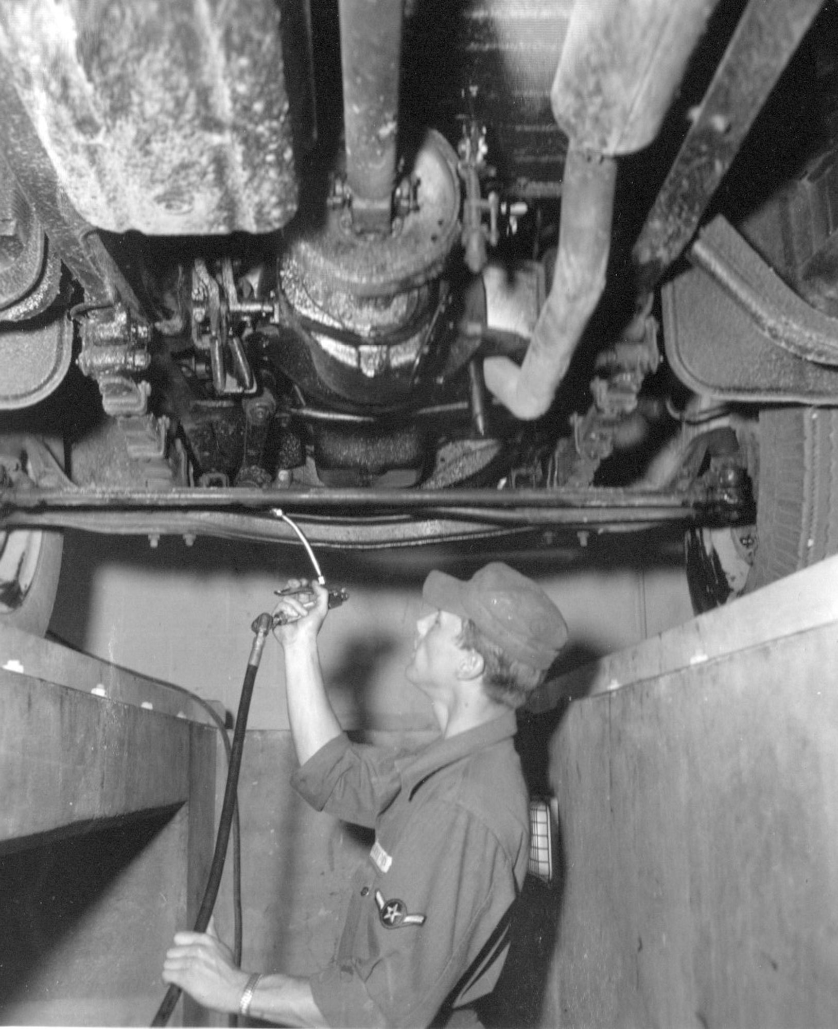 An unidentified Airman of the 142nd Motor Vehicle Squadron services a vehicle of the unit during annual training at Gowen Field, Juen 21, 1954.  (Courtesy 142FW History Archives)