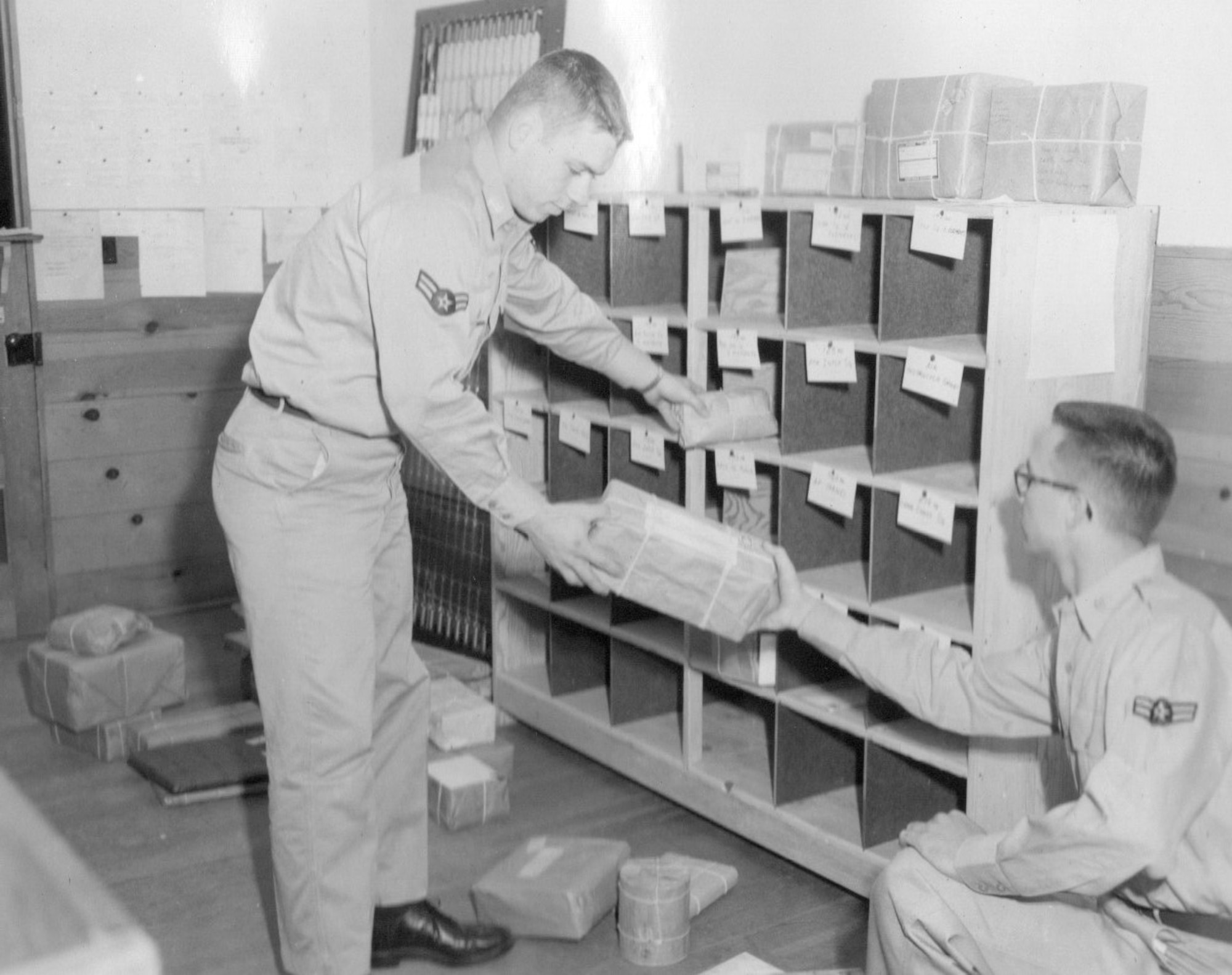 Airmen sort packages sent to OreANG Guardsmen during the annual training at Gowen Field, June 18, 1954.  Note the common use of string on the packaging.  (Courtesy 142FW History Archives)