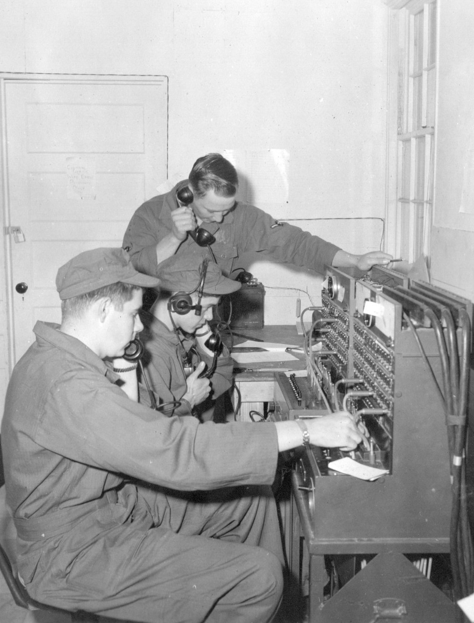 Airmen of the 142nd Communications Squadron operate a telephone switchboard during annual training at Gowen Field, June 17, 1954. (Courtesy 142FW History Archives)