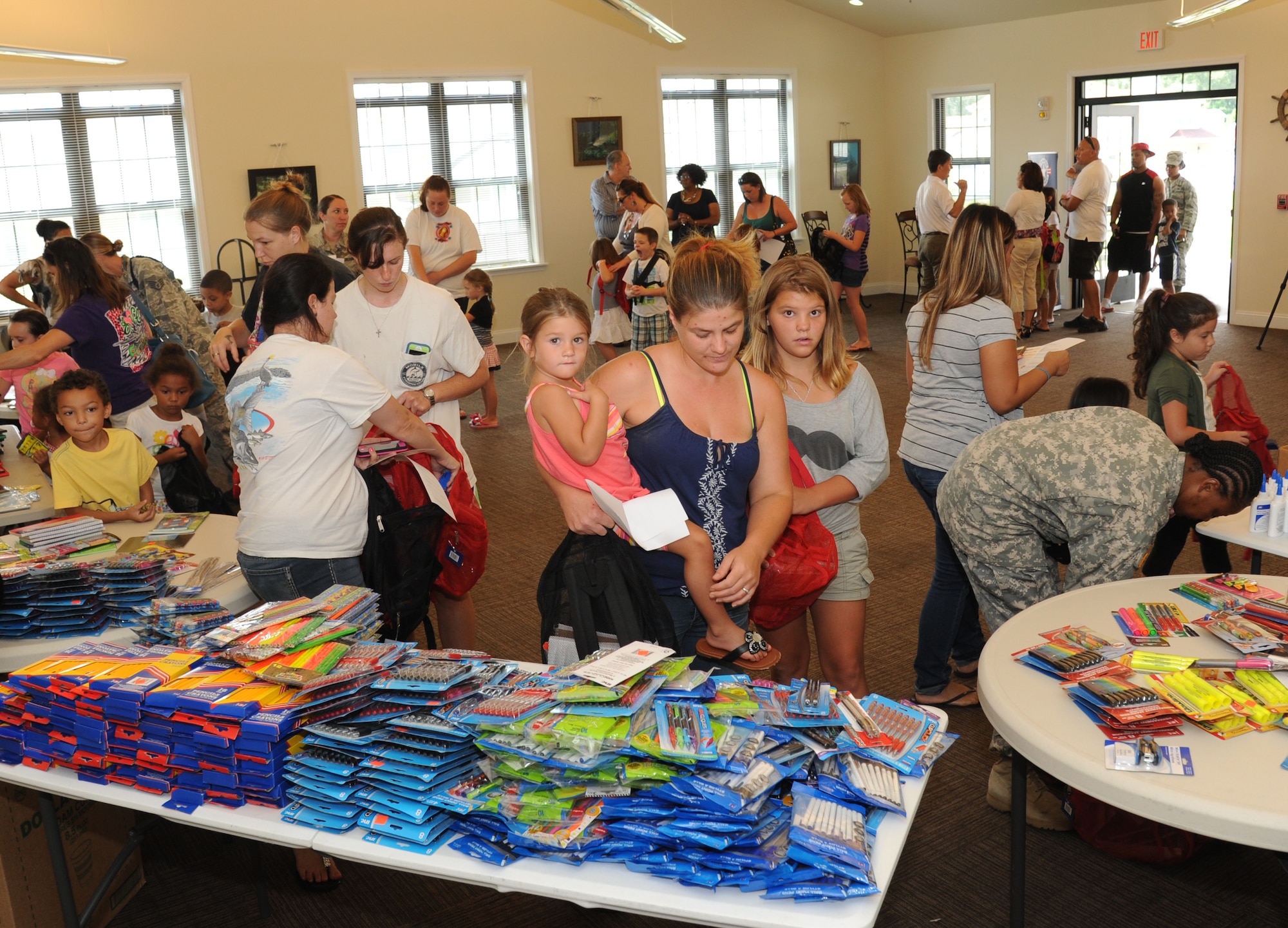 Military families take advantage of a backpack and school supplies give-away event July 29, 2014, at the Bay Ridge Community Center, Keesler Air Force Base, Miss.  The 81st Force Support Squadron and Operation Home Front partnered together to host the event for military families. (U.S. Air Force photo by Kemberly Groue)
