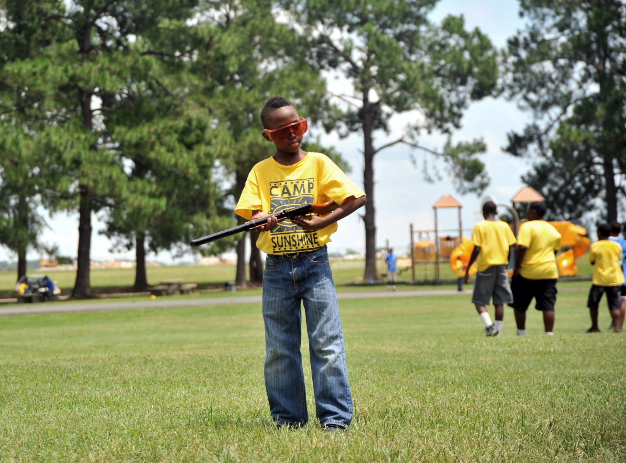 A Camp Sunshine participant locks the safety on his BB gun during weapons safety training at Maxwell Air Force Base July 22, 2014. This is the 12th year Maxwell is hosting the Camp Sunshine Program. The annual program allows Airmen to mentor local area boys through a week of activities including swimming, basketball and arts and crafts. (U.S. Air Force photo by Master Sgt. Michael Voss)