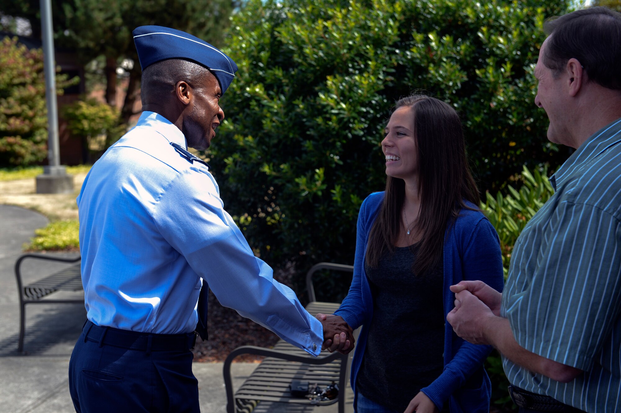 Gen. Darren McDew (left), Air Mobility Command commander, coins Ms. Jennifer Hawkins, 62nd Operations Support Squadron host aviation resource management technician, for excellence July 25, 2014, during an official base visit at Joint Base Lewis-McChord, Wash. Hawkins was identified by her leadership as a star performer resulting in the opportunity to meet McDew. (U.S. Air Force photo/Staff Sgt. Russ Jackson)