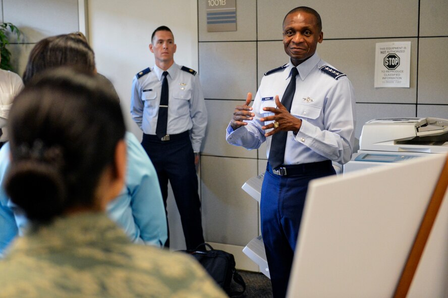 Gen. Darren McDew, Air Mobility Command commander explains the importance of joint base relationships to members of the 627th Force Support Squadron July 25, 2014, during an official base visit at Joint Base Lewis-McChord, Wash. The 627th FSS Airmen gave McDew and overview of how their joint partnership with their Army counterparts accomplish the Department of Defense mission. (U.S. Air Force photo/Staff Sgt. Russ Jackson)