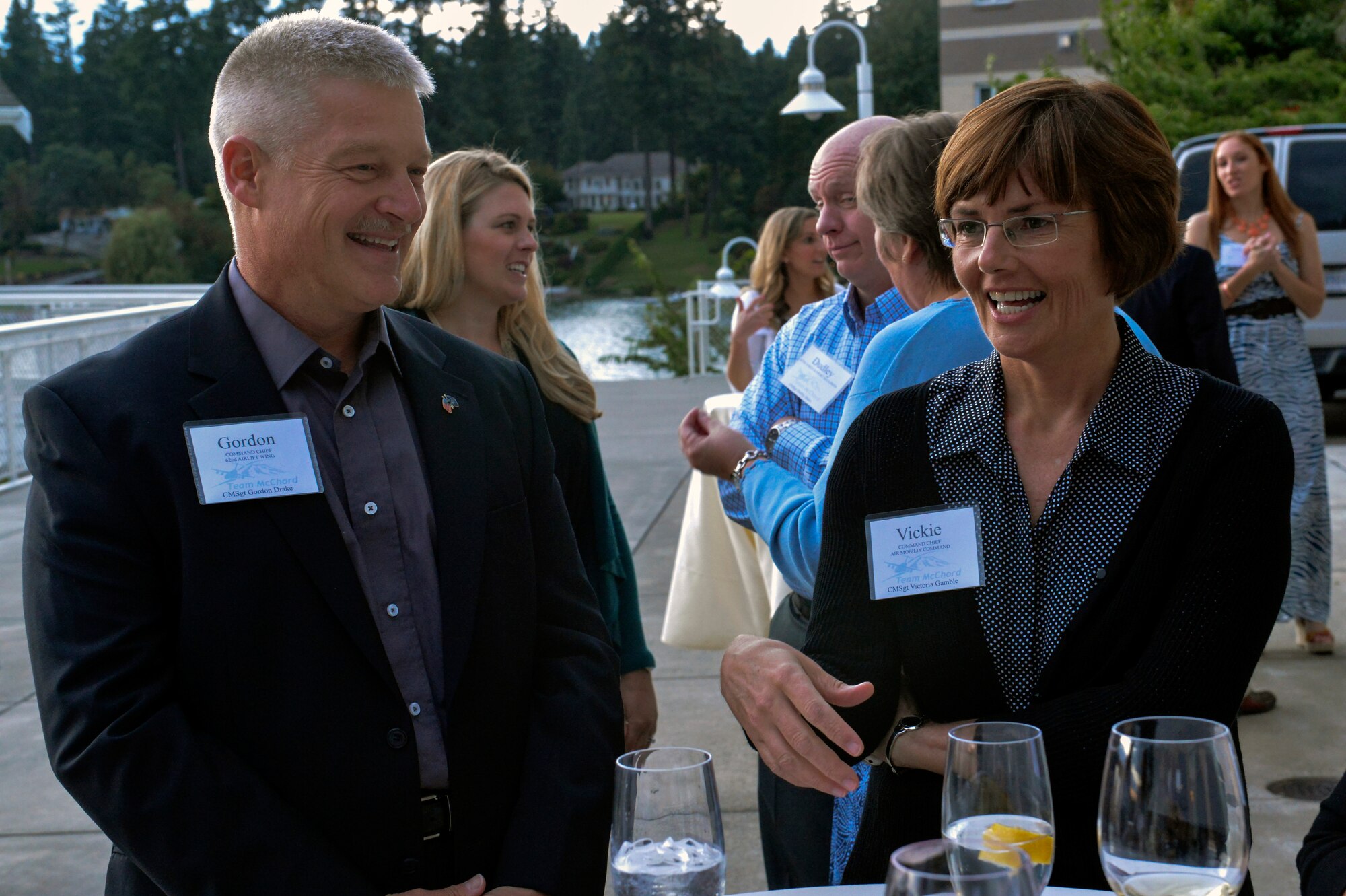 Chief Master Sgt. Gordon Drake, 62nd Airlift Wing command chief shares stories with Chief Master Sgt. Victoria Gamble, Air Mobility Command command chief July 24, 2014, at a civic leader social with base and community leaders at the Tacoma Country and Golf Club. The chiefs appreciated an easygoing evening chatting with base leaders, spouses and community members. (U.S. Air Force photo/Staff Sgt. Russ Jackson)