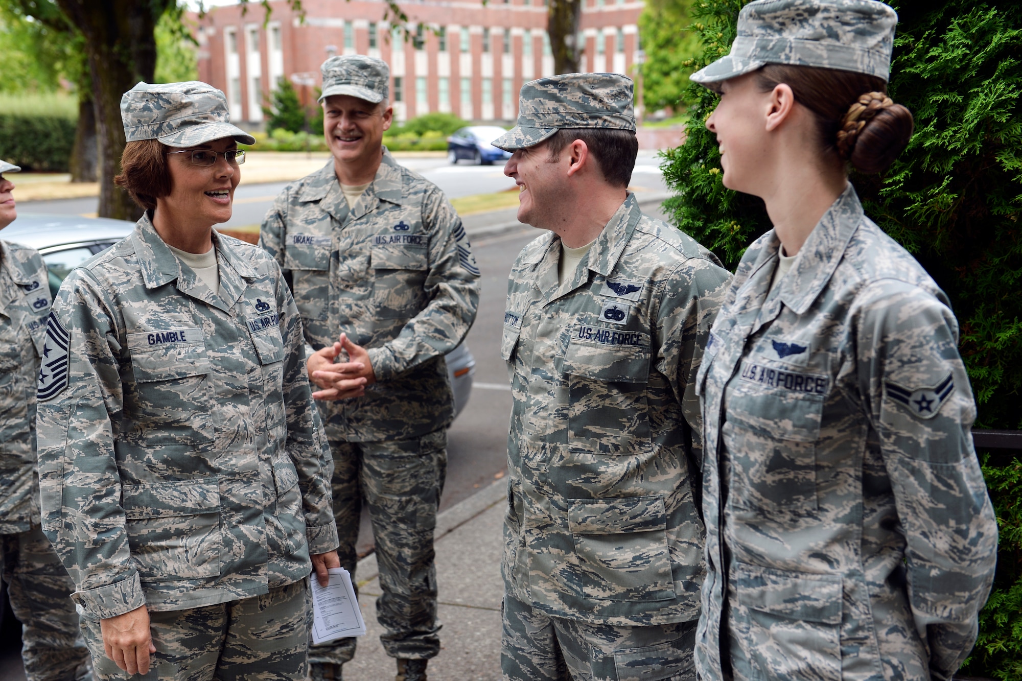 Chief Master Sgt. Victoria Gamble (left), Air Mobility Command command chief, visits with Staff Sgt. James Sidebottom, and Airman 1st Class Shannon Gorton, 7th Airlift Squadron loadmasters July 24, 2014 during Gen. Darren McDew, Air Mobility Command commander’s official visit to Joint Base Lewis-McChord, Wash. Gamble spoke with the Airmen prior to McDew’s arrival where he coined Gorton for being a star performer. (U.S. Air Force photo/Staff Sgt. Russ Jackson)