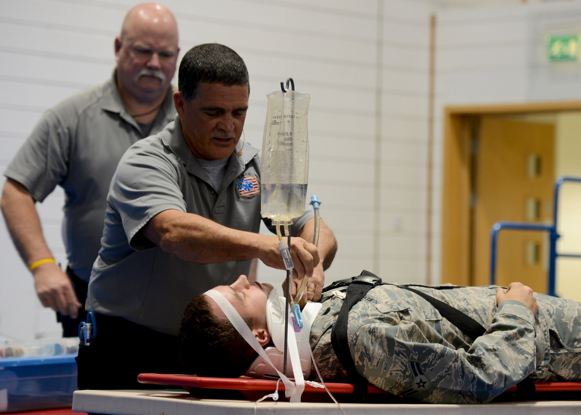 Ronny Garcia, Street Smart presenter, performs a simulated medical exam on U.S. Air Force Airman 1st Class Justin Howard, 48th Logistics Readiness Squadron vehicle maintainer from Warrenton, Va., July 28, 2014, on RAF Lakenheath, England. The hour-long Street Smart program consisted of real-life depictions of vehicle accidents. (U.S. Air Force photo/Airman 1st Class Victoria H. Taylor/Released)