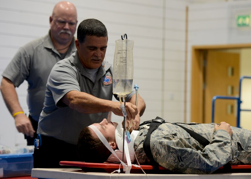 Ronny Garcia, Street Smart presenter, performs a simulated medical exam on U.S. Air Force Airman 1st Class Justin Howard, 48th Logistics Readiness Squadron vehicle maintainer from Warrenton, Va., July 28, 2014, on RAF Lakenheath, England. The hour-long Street Smart program consisted of real-life depictions of vehicle accidents. (U.S. Air Force photo/Airman 1st Class Victoria H. Taylor/Released)