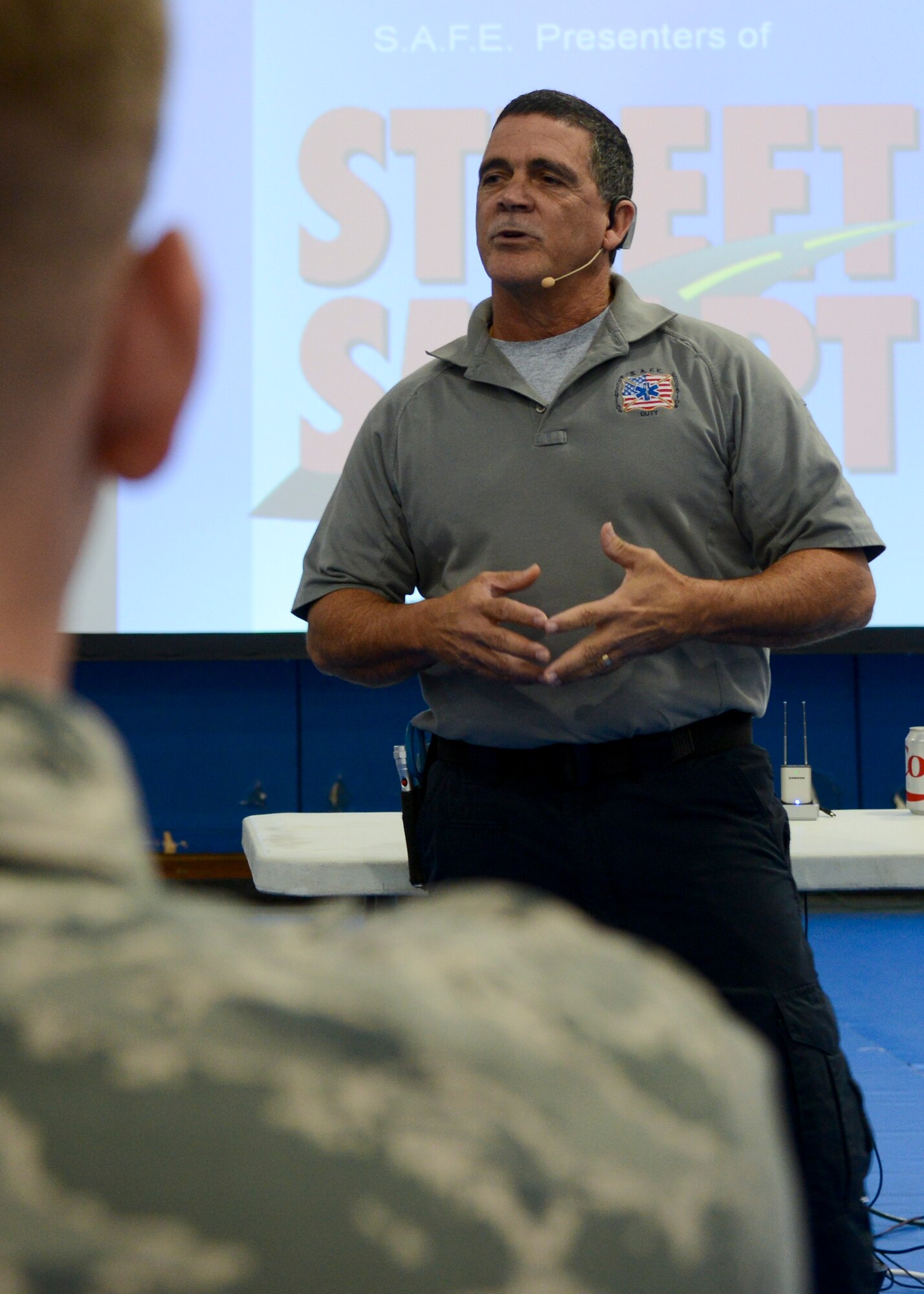 Ronny Garcia, Street Smart presenter and paramedic with Tampa Florida Fire Rescue, briefs Airmen July 28, 2014, on RAF Lakenheath, England. The program gave examples to those in attendance on serious consequences that can result from distracted drivers. (U.S. Air Force photo/Airman 1st Class Victoria H. Taylor/Released)