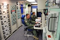 Missile combat crew members 2nd Lt. Wesley Griffith (left) and 1st Lt. Katie Grimley, both from the 10th Missile Squadron, Malmstrom Air Force Base, work in the launch control center of missile alert facility Alpha-01 on July 15. The base successfully completed its codes change program July 25, updating all 150 launch facilities and 15 launch control centers, ensuring the base’s arsenal of Minuteman III Intercontinental Ballistic Missiles remain a safe, secure and effective strategic deterrent for America. (U.S. Air Force photo/Josh Aycock)