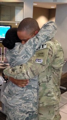 Capt. Ralph "R.J" Johnson hugs his wife 1st Lt. Cara Bousie-Johnson after returning home from deployment Aug. 22, 2013 at the Valdosta Regional Airport, Valdosta, Ga. (Courtesy Photo/Released) 