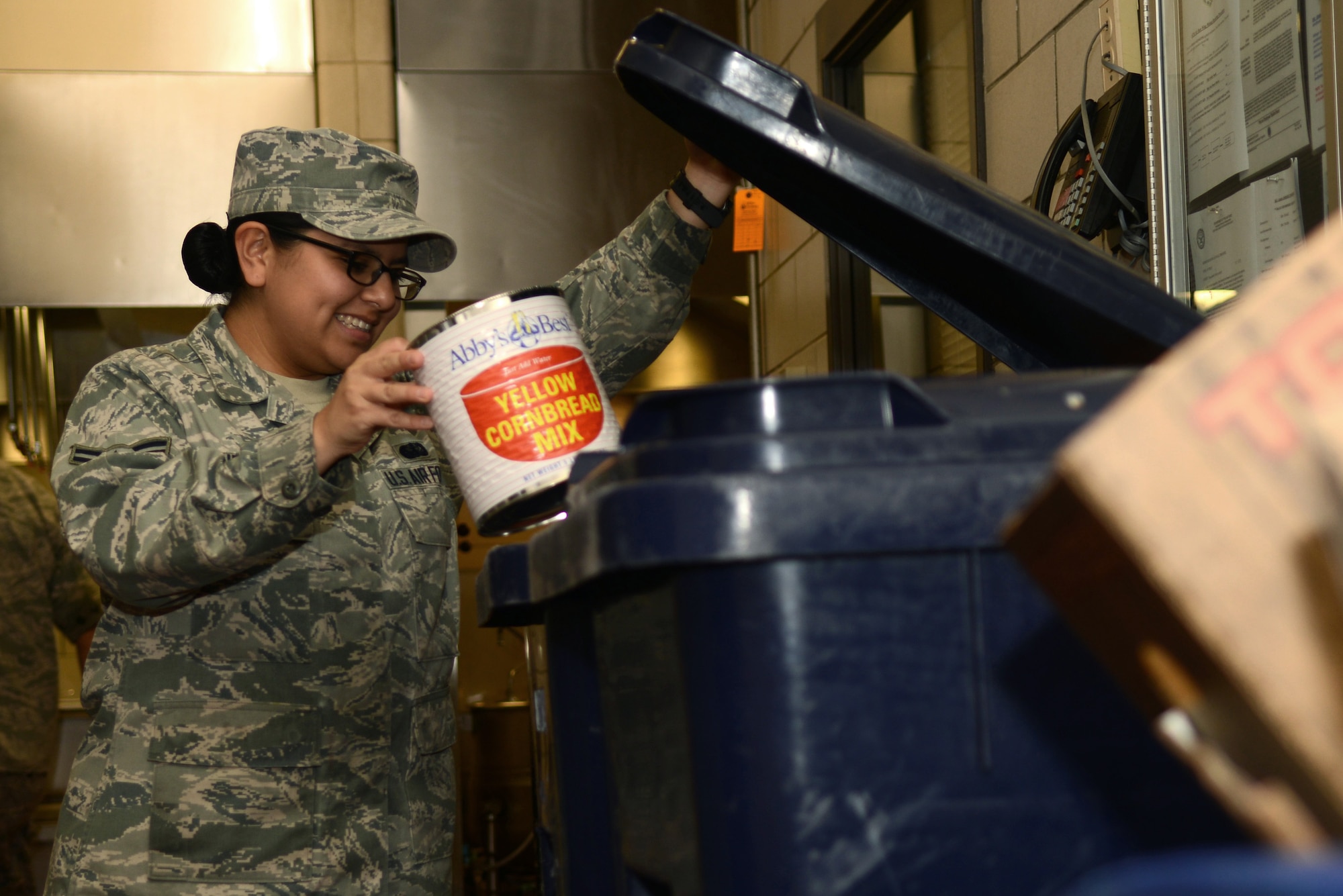 U.S. Air Force Airman 1st Class Emery Andrade recycles a can at the Crossbow Dining Facility at Langley Air Force Base, Va., July 28, 2014. Supplies that come to the dining facility in cardboard, metal or plastic are either recycled or repurposed for later use. (U.S. Air Force photo by Airman 1st Class Devin Scott Michaels)