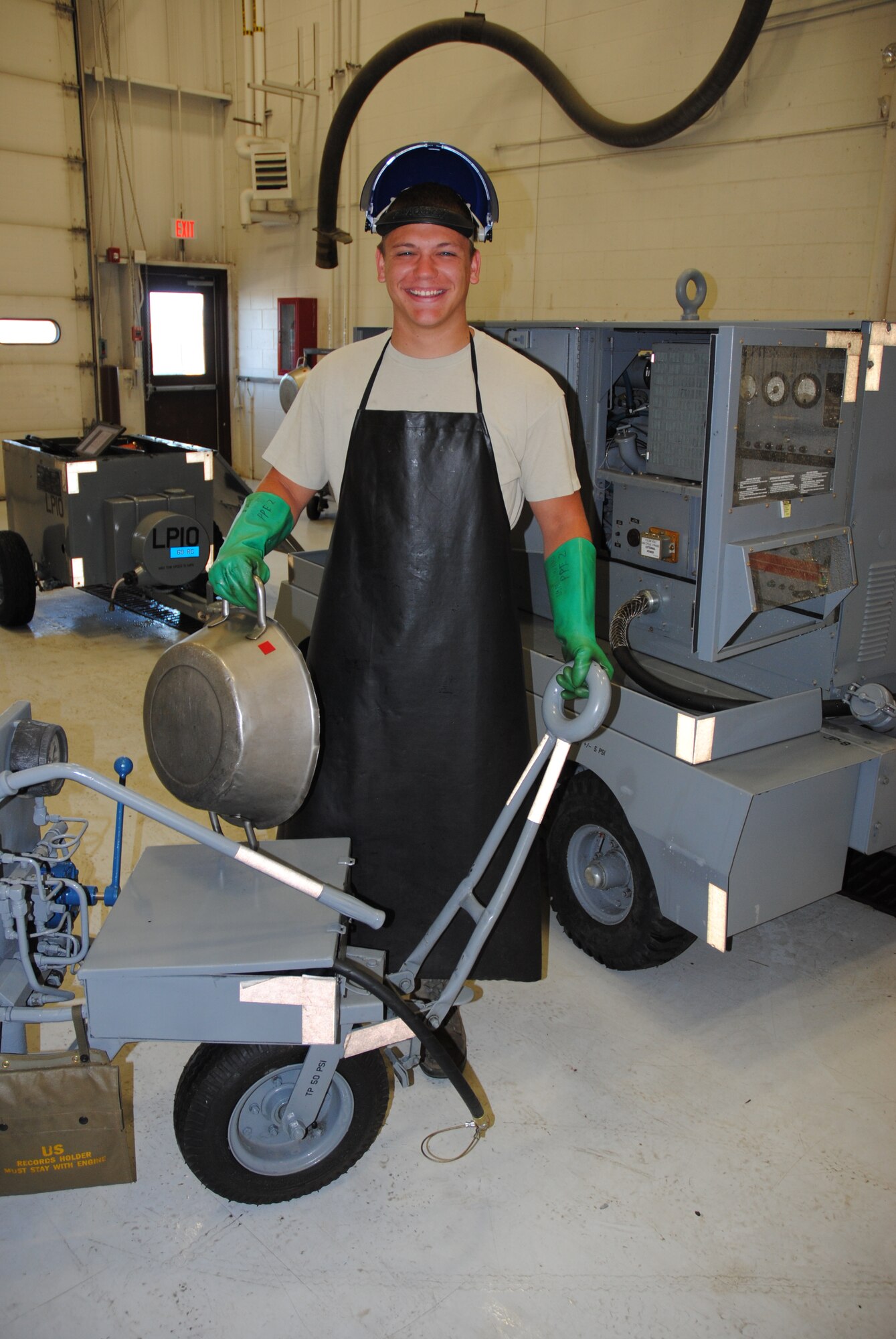 Senior Airman Jacob Schmoltze, 69th Maintenance Squadron Aerospace Ground Equipment mechanic, stands in the Aerospace Ground Equipment shop on Grand Forks Air Force Base, N.D., July 28, 2014, The 21-year-old Airman from Ashland, Penn., is the base’s Warrior of the Week for the final week of July 2014. (U.S. Air Force photo/Staff Sgt. Luis Loza Gutierrez)