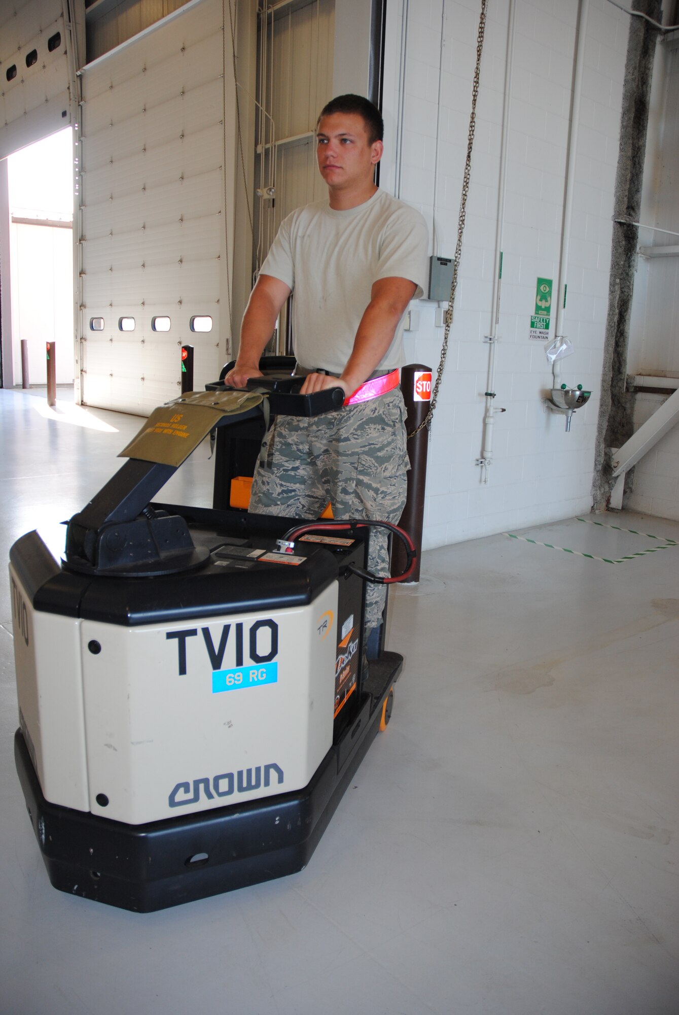 Senior Airman Jacob Schmoltze, 69th Maintenance Squadron Aerospace Ground Equipment mechanic, maneuvers an electronic tow vehicle into position after using it to move heavy equipment from one location to another on July 28, 2014, in the Aerospace Ground Equipment shop on Grand Forks Air Force Base, N.D. The 21-year-old Airman from Ashland, Penn., is the base’s Warrior of the Week for the final week of July 2014. (U.S. Air Force photo/Staff Sgt. Luis Loza Gutierrez)