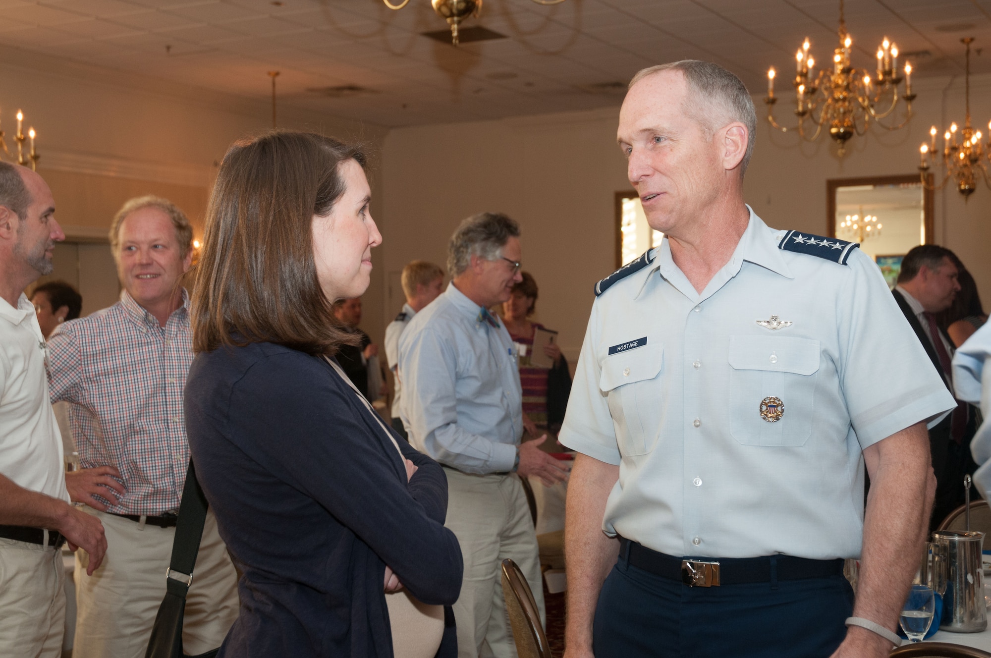 Katie Enos, U.S. Congresswoman Niki Tsongas’ chief of staff, and U.S. Air Force Gen. Mike Hostage, commander of Air Combat Command, discuss defense acquisition programs and how they integrate into the service’s combat air forces during a Military Affairs Council luncheon at Hanscom Air Force Base, Mass., July 29. Focused on future capabilities that will meet the needs of combatant commanders, Hostage emphasized the importance of Hanscom’s acquisition programs and how they relate to today’s modern day battlefield. (U.S. Air Force photo by Mark Herlihy) 