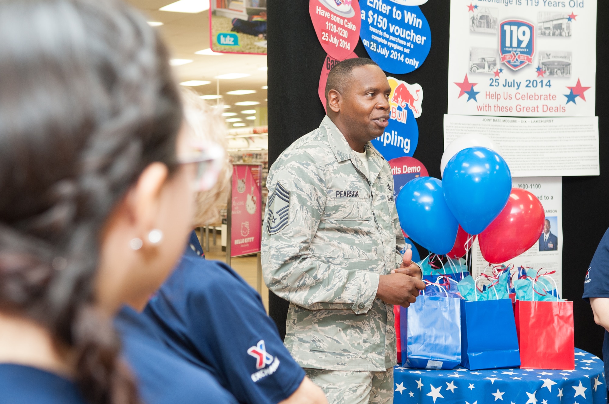 Chief Master Sgt. Tony Pearson, Army and Air Force Exchanges Service's senior enlisted advisor, talks to AAFES employees before cutting a cake to celebrate the Exchange's 119th birthday July 25, 2014, at Joint Base McGuire-Dix-Lakehurst, N.J. Pearson toured Exchange facilities, met with Airmen, Soldiers and community members and addressed how the Exchange can serve them better, including growing the selection of name-brand services offered on the installation. (U.S. Air Force photo by Russell Meseroll/Released)