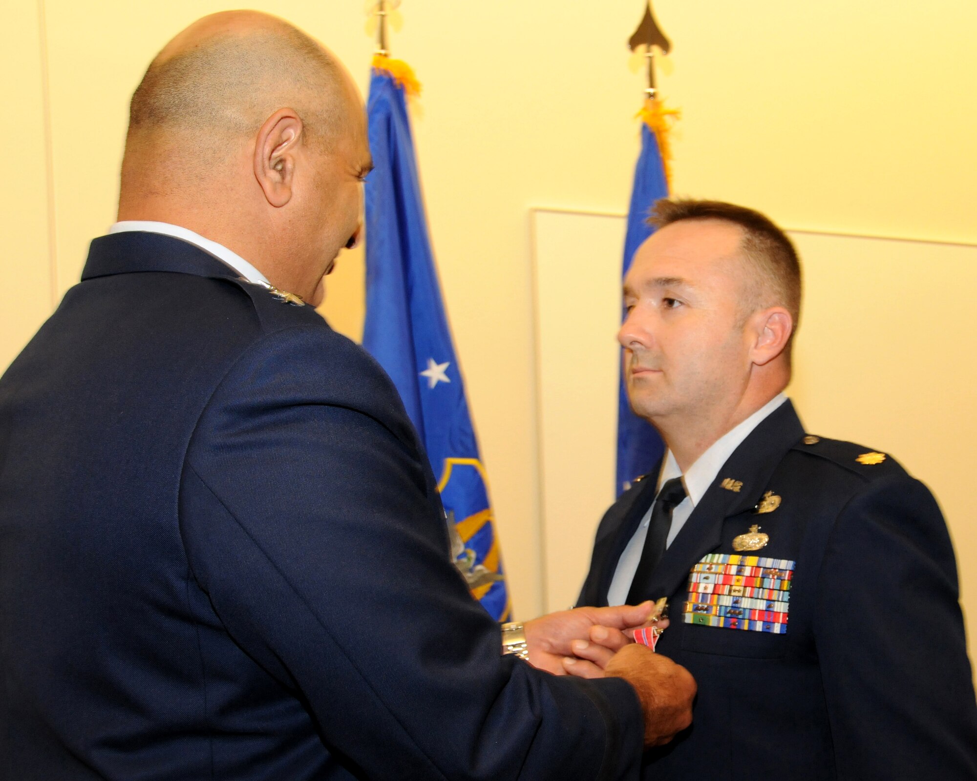 Maj. Gen. Richard Haddad, Air Force Reserve Command vice commander, attaches the Bronze Star Medal to the lapel of Maj. Jonathan Whittaker, AFRC Force Management branch chief, during a ceremony July 29, 2014 at Robins Air Force Base, Georgia. Whittaker earned the Bronze Star Medal for his actions in Kandahar, Afghanistan, from November 29, 2012 through November 17, 2013. (U.S. Air Force photo/ Tech. Sgt. Shanda L. De Anda)