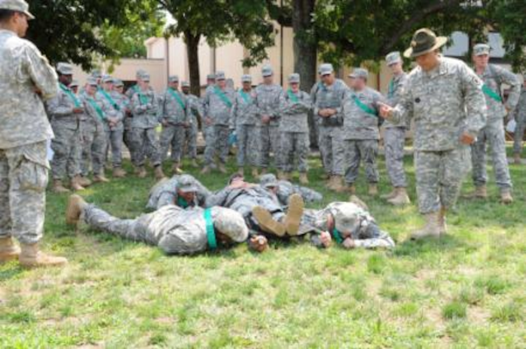 Sgt. 1st Class Victor Rivera, Senior Drill Sergeant, 1st Battalion, 304th Infantry Regiment gives Alpha Company Soldiers instruction on how to move an injured Soldier while in the prone position during the Combat Life Saver course at Operation Sustainment Warrior 2014 Joint Base McGuire-Dix-Lakehurst, N.J. OSW is designed to provide rigorous and relevant individual training that improves Soldier readiness and retention. (Photo by Spc. C. Terrell Turner, 214th MPAD/Released)