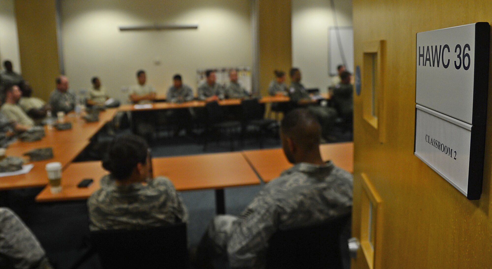 Airmen from the 48th Aerospace Medicine Squadron attend  a briefing during preventative environmental sustainment training at Royal Air Force Lakenheath, England, July 25, 2014. The briefing was followed by hands-on training, which provided Airmen the opportunity to learn about other Air Force specialty jobs within their unit, to better prepare them for situations they may encounter in a deployed environment. (U.S. Air Force photo by Airman 1st Class Erin O’Shea/Released) 