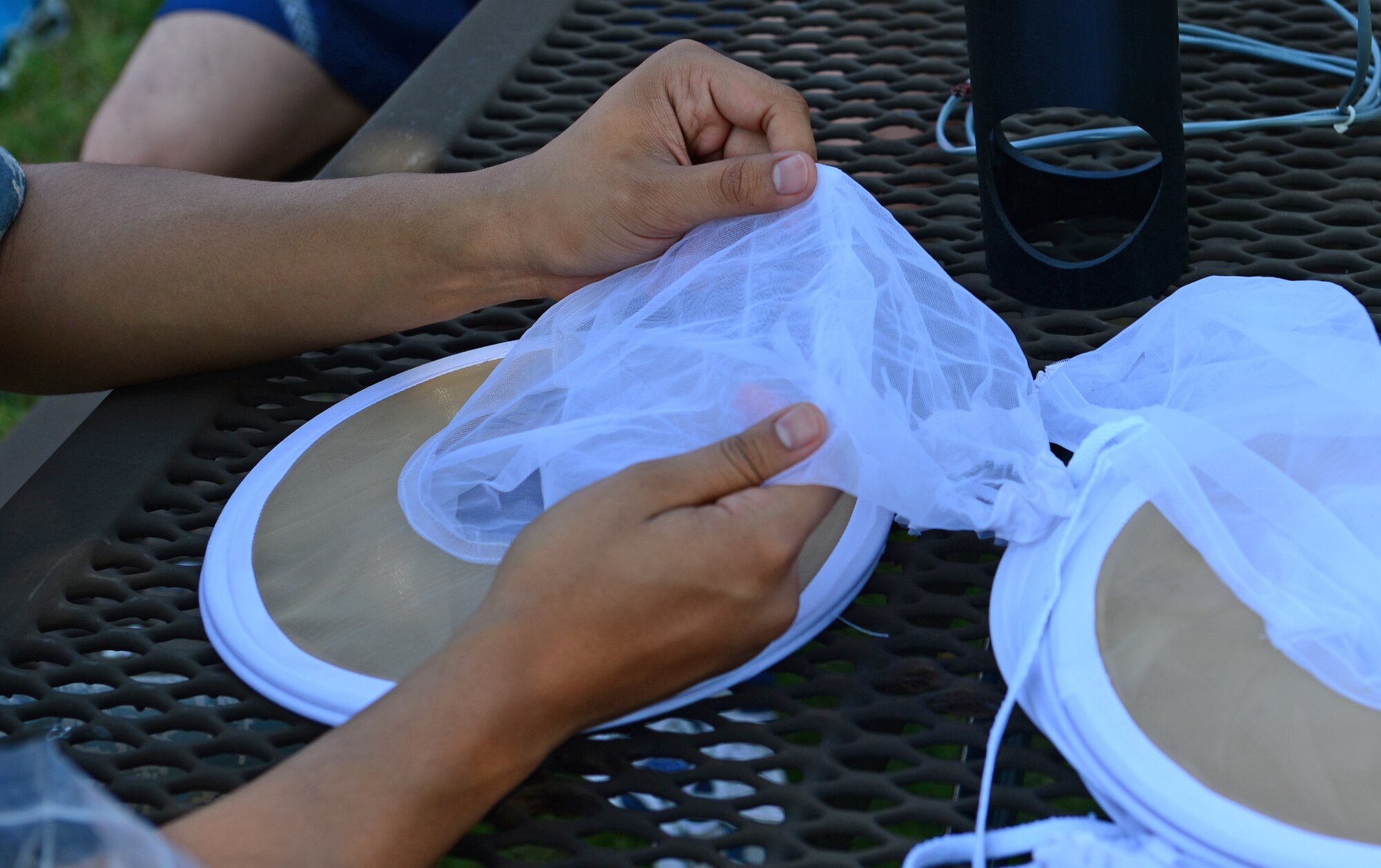 An Airman assigned to the 48th Aerospace Medicine Squadron, inspects a mosquito trap during a briefing about protection and trapping at Royal Air Force Lakenheath, England, July 25, 2014. Some members participated in Biannual preventative environmental sustainment training to broaden their knowledge about medical specialties within their unit. (U.S. Air Force photo by Airman 1st Class Erin O’Shea/Released) 