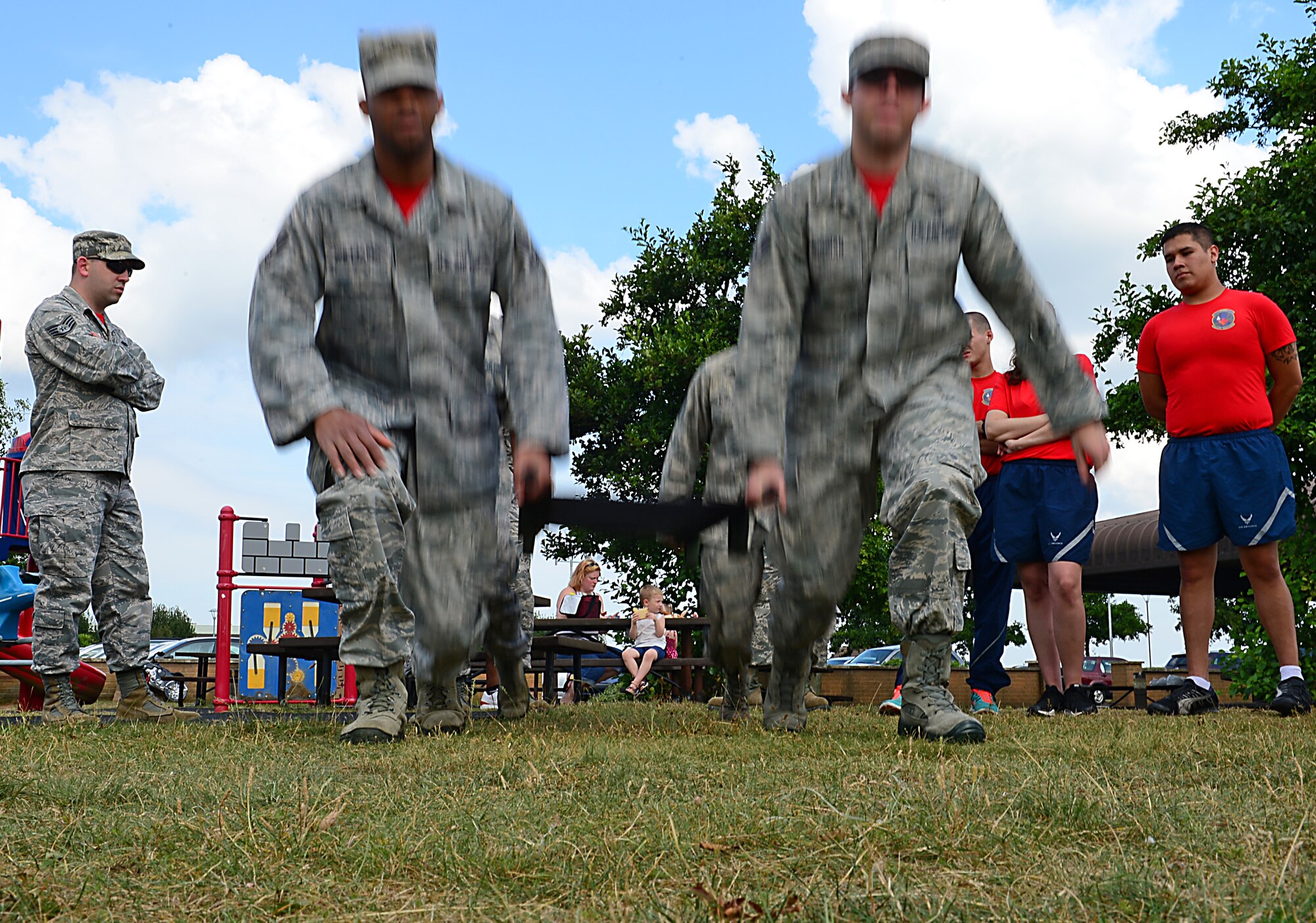 Airmen assigned to the 48th Aerospace Medicine Squadron lift a litter during a preventative environmental sustainment training event at Royal Air Force Lakenheath, England, July 25, 2014. The two-day, hands-on training gave Airmen the opportunity to learn about other Air Force specialty jobs within their unit, to prepare them for situations they may encounter in a deployed environment. (U.S. Air Force photo by Airman 1st Class Erin O’Shea/Released) 