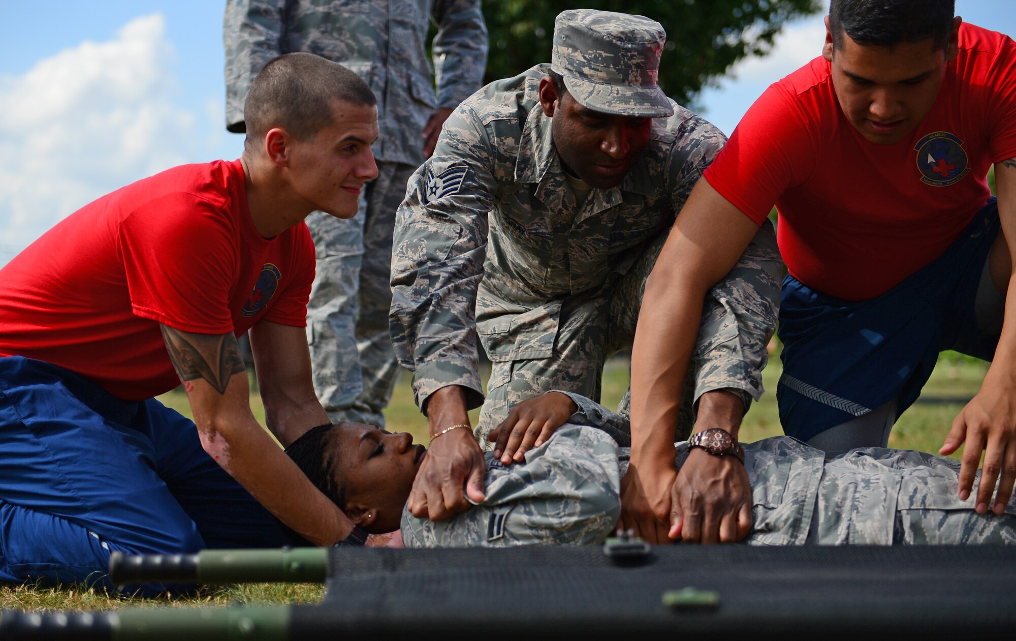 Airmen assigned to the 48th Aerospace Medicine Squadron prepare to lift Airman 1st Class Kivone Pernell, 48th AMDS bioenvironmental technician, onto a litter during an exercise at Royal Air Force Lakenheath, England, July 25, 2014. Some members participated in Biannual preventative environmental sustainment training to broaden their knowledge about medical specialties within their unit. (U.S. Air Force photo by Airman 1st Class Erin O’Shea/Released) 